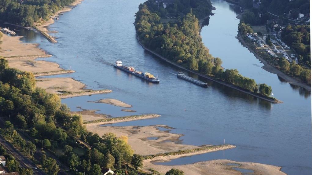 Cargo ships travel on the Rhine River on August 10, 2022 near Bonn, Germany. The ongoing hot weather and lack of rain have caused water levels on the Rhine to fall, which is complicating shipping. (Photo: Andreas Rentz, Getty Images)