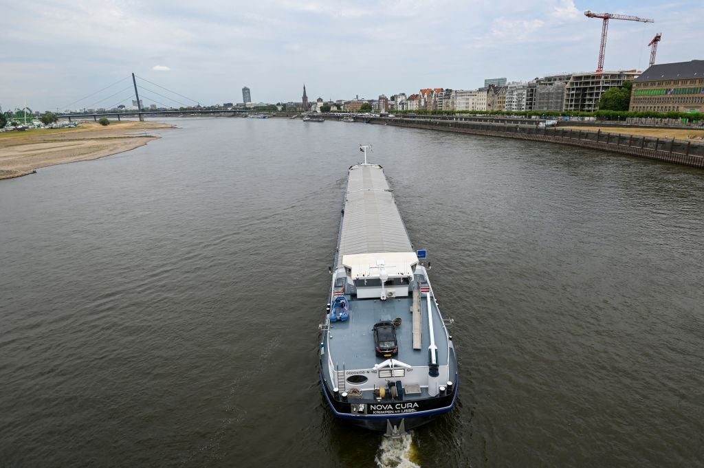 An inland vessel navigates on the Rhine as the partially dried-up river bed is seen in Duesseldorf, Germany, in late July as Europe experiences a heatwave.  (Photo: INA FASSBENDER/AFP, Getty Images)