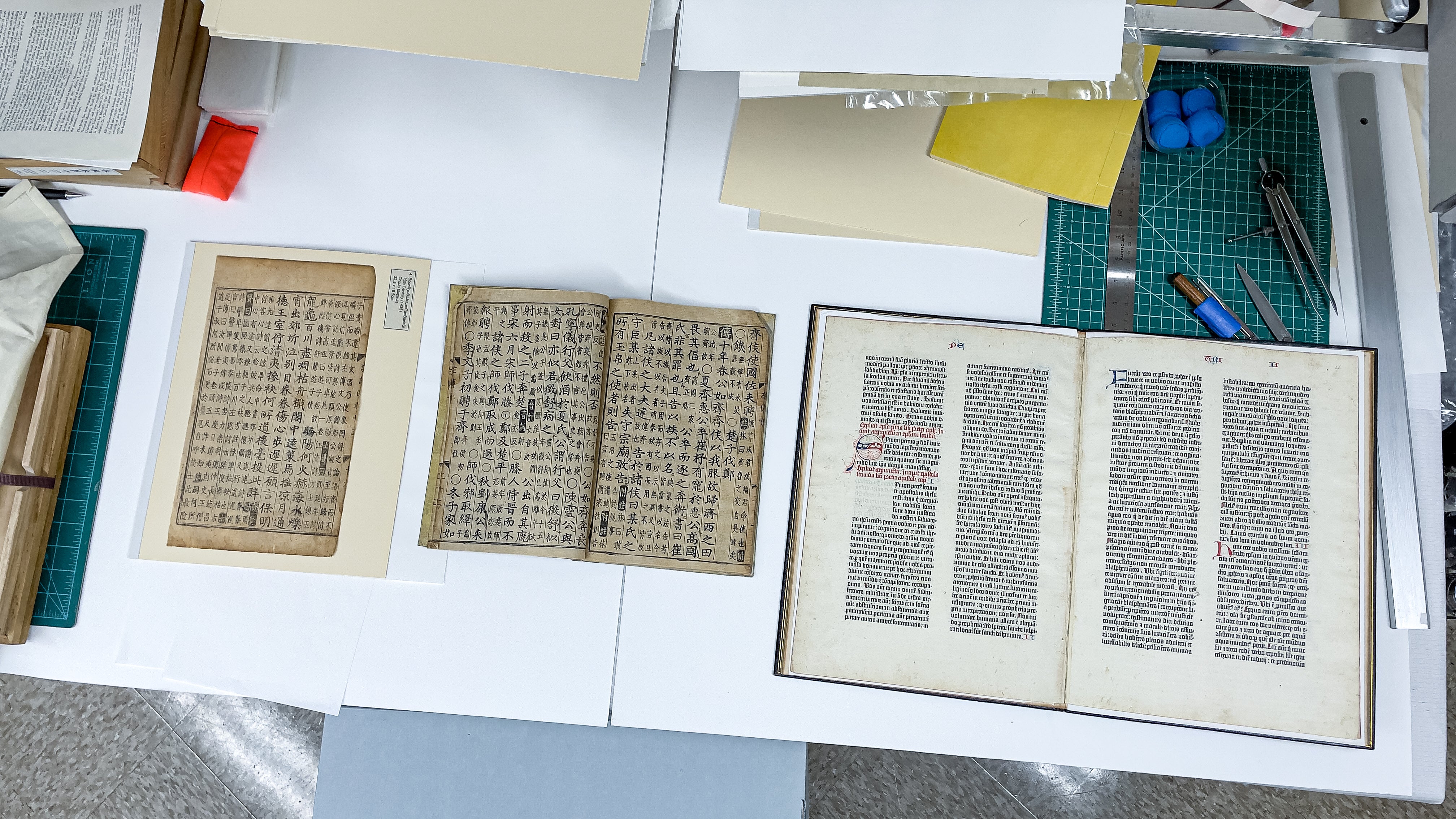 Two Korean documents and leaves of the Gutenberg Bible side-by-side at SLAC. (Photo: Jacqueline Ramseyer Orrell/SLAC National Accelerator Laboratory)