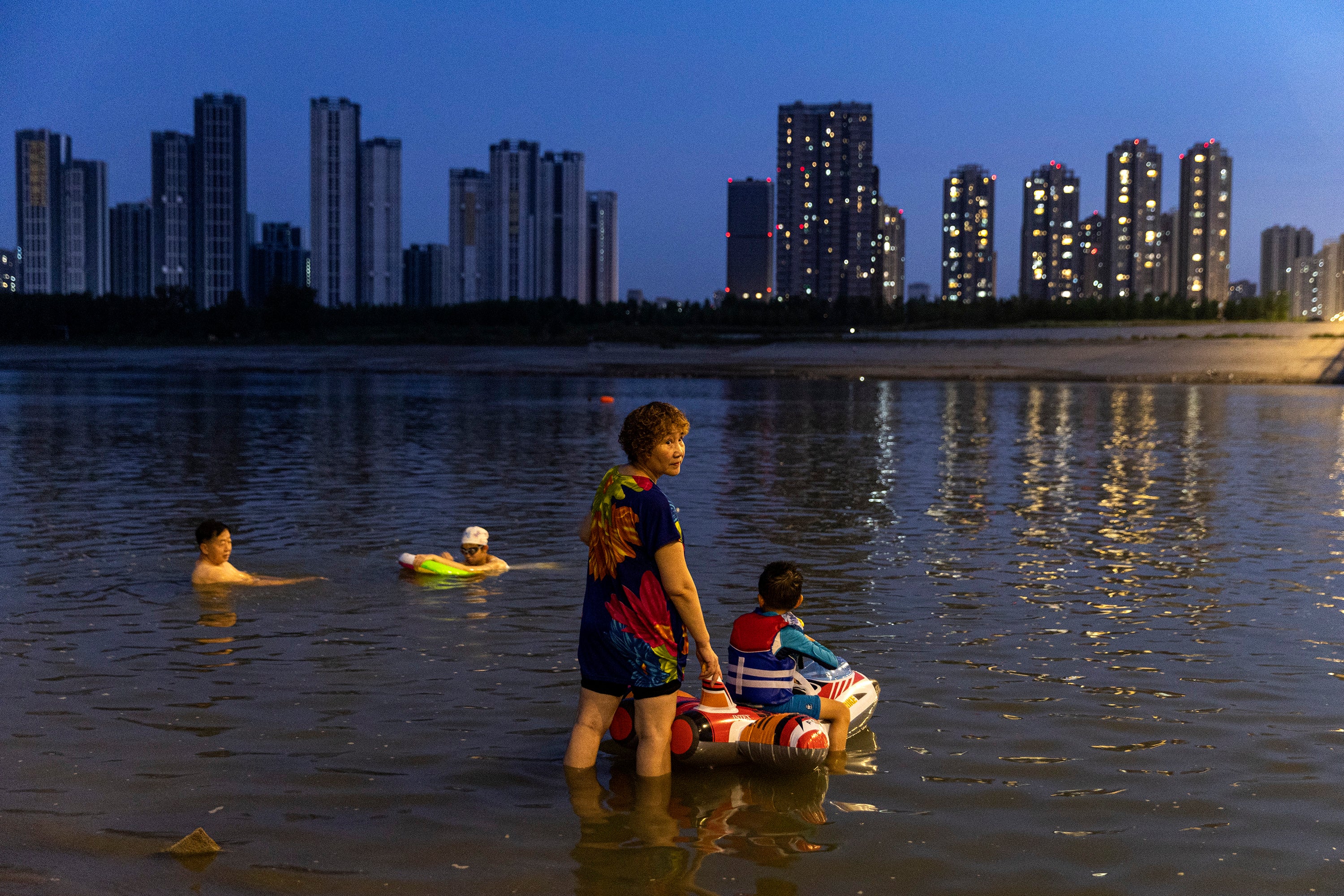 People swim in the Han River in Wuhan, Hubei Province, on August 19.  (Photo: China Out, Getty Images)
