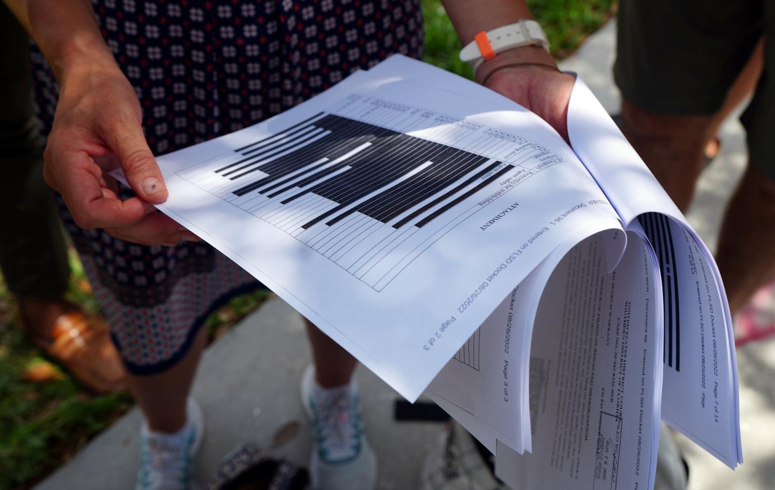 Journalists gather outside the Paul S. Rogers Federal Building and U.S. Courthouse in downtown West Palm Beach, Fla., to read a heavily blackout document released by The Justice Department Friday, Aug. 26, 2022. (Photo: Jim Rassol, AP)