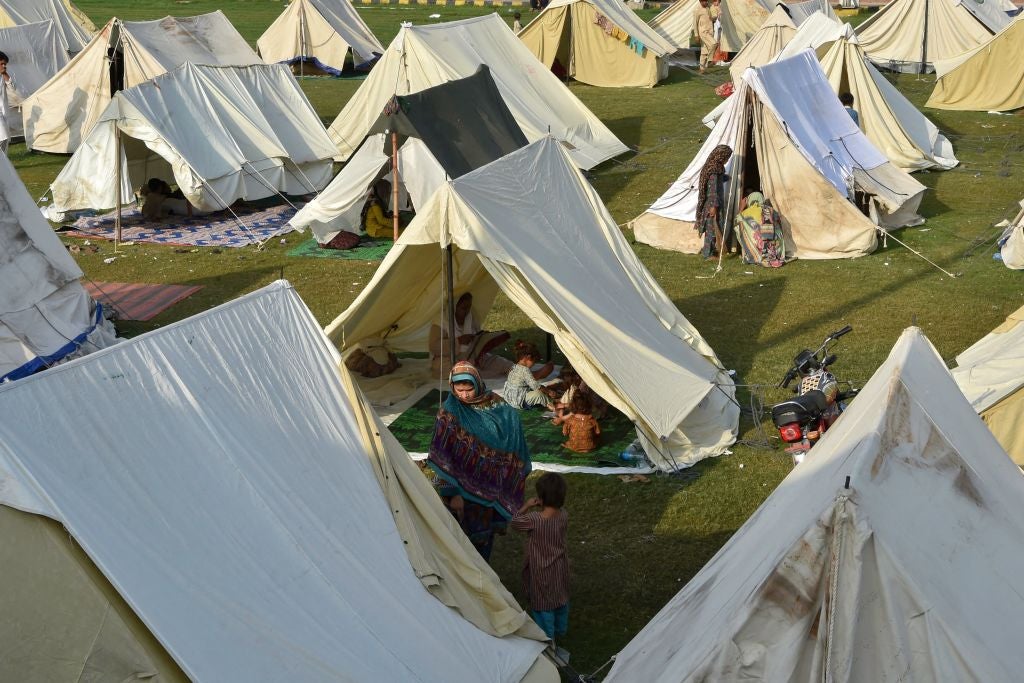 Displaced people sit in their tents at a makeshift camp after fleeing from their flood-hit homes following heavy monsoon rains in Charsadda district of Khyber Pakhtunkhwa on August 29, 2022. (Photo: ABDUL MAJEED/AFP, Getty Images)