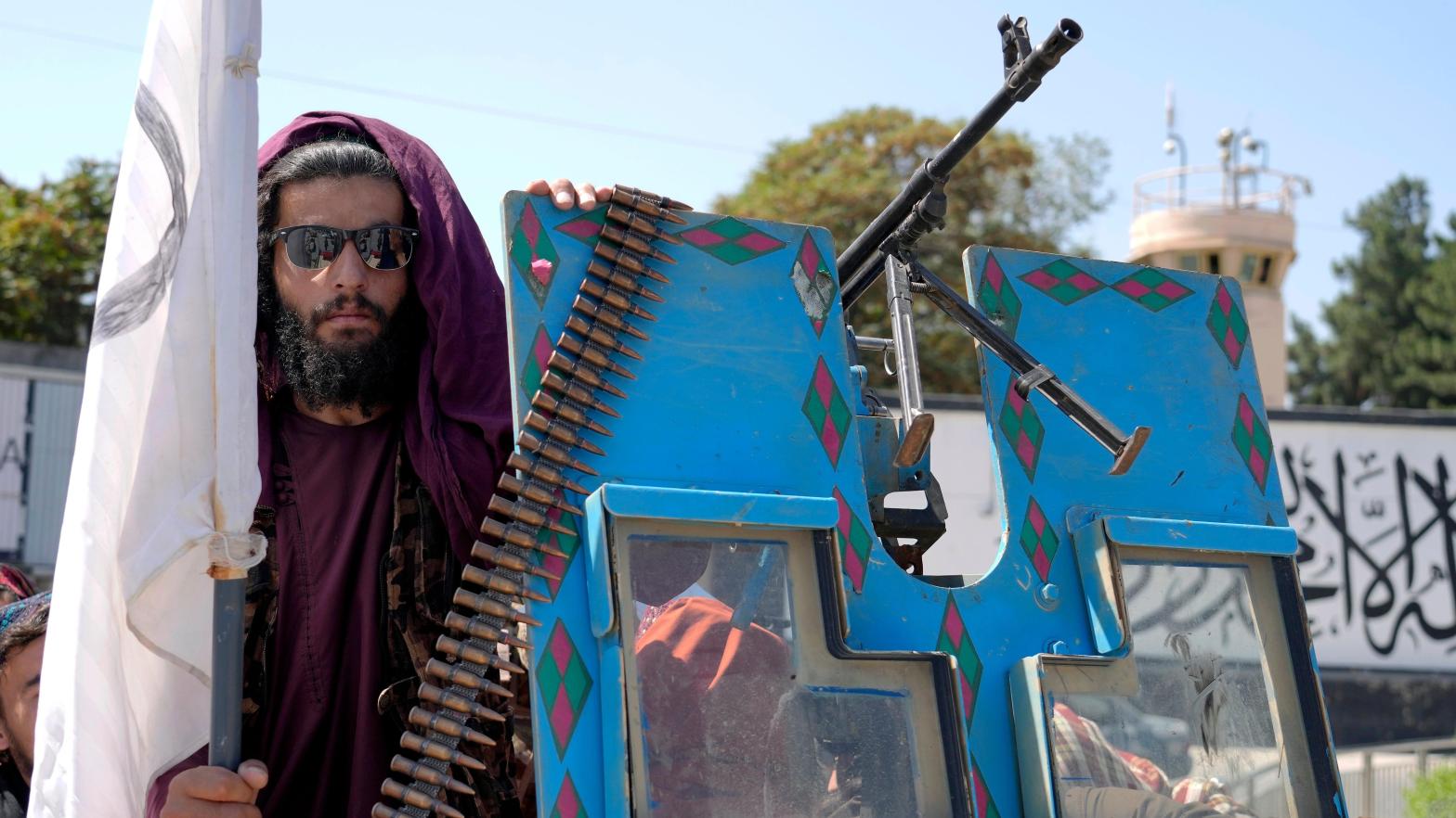 A Taliban fighter poses in front of the U.S. Embassy in Kabul during a celebration marking the first anniversary of the withdrawal of US-led troops from Afghanistan. (Photo: Ebrahim Noroozi, AP)