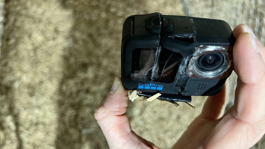 A GoPro with two larges slices taken out of it