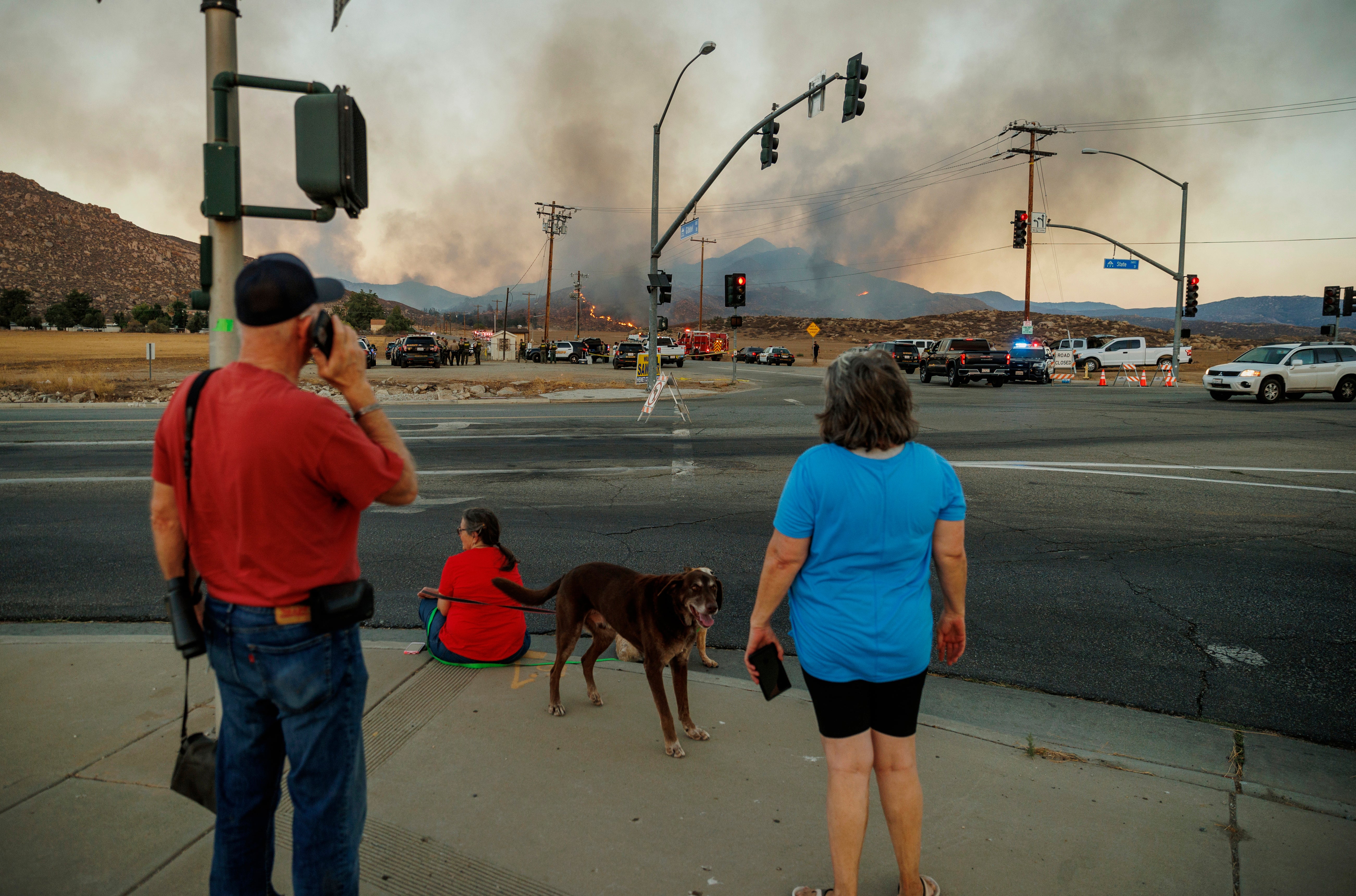 People watch a plume of smoke from the Fairview Fire from a distance on Monday, Sept. 5, 2022, near Hemet, California. (Photo: Ethan Swope, AP)