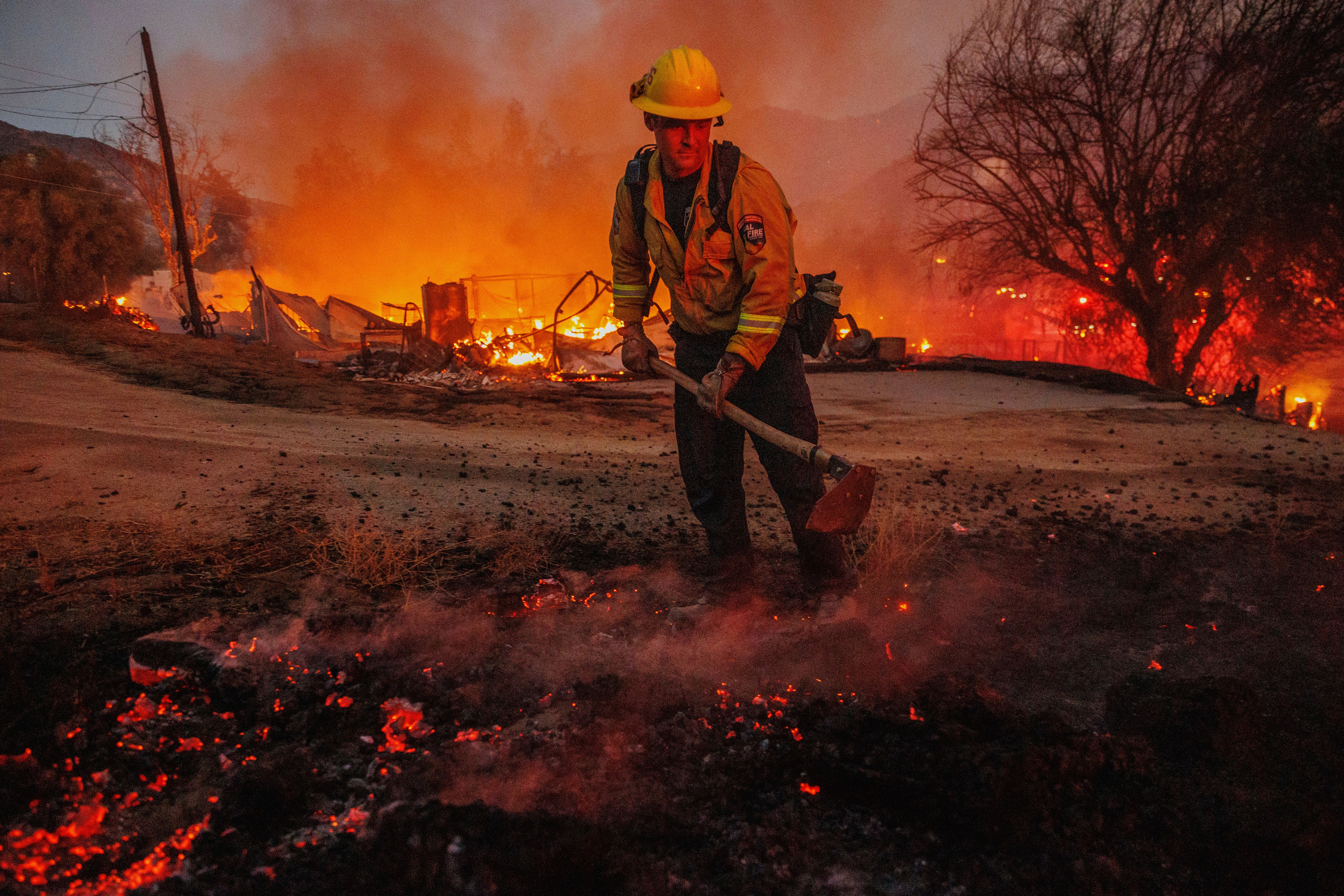 Ian Fremd, of the Beaumont Fire Department, takes down hot spots while battling the Fairview Fire on Monday, Sept. 5, 2022, near Hemet, California.  (Photo: Ethan Swope, AP)