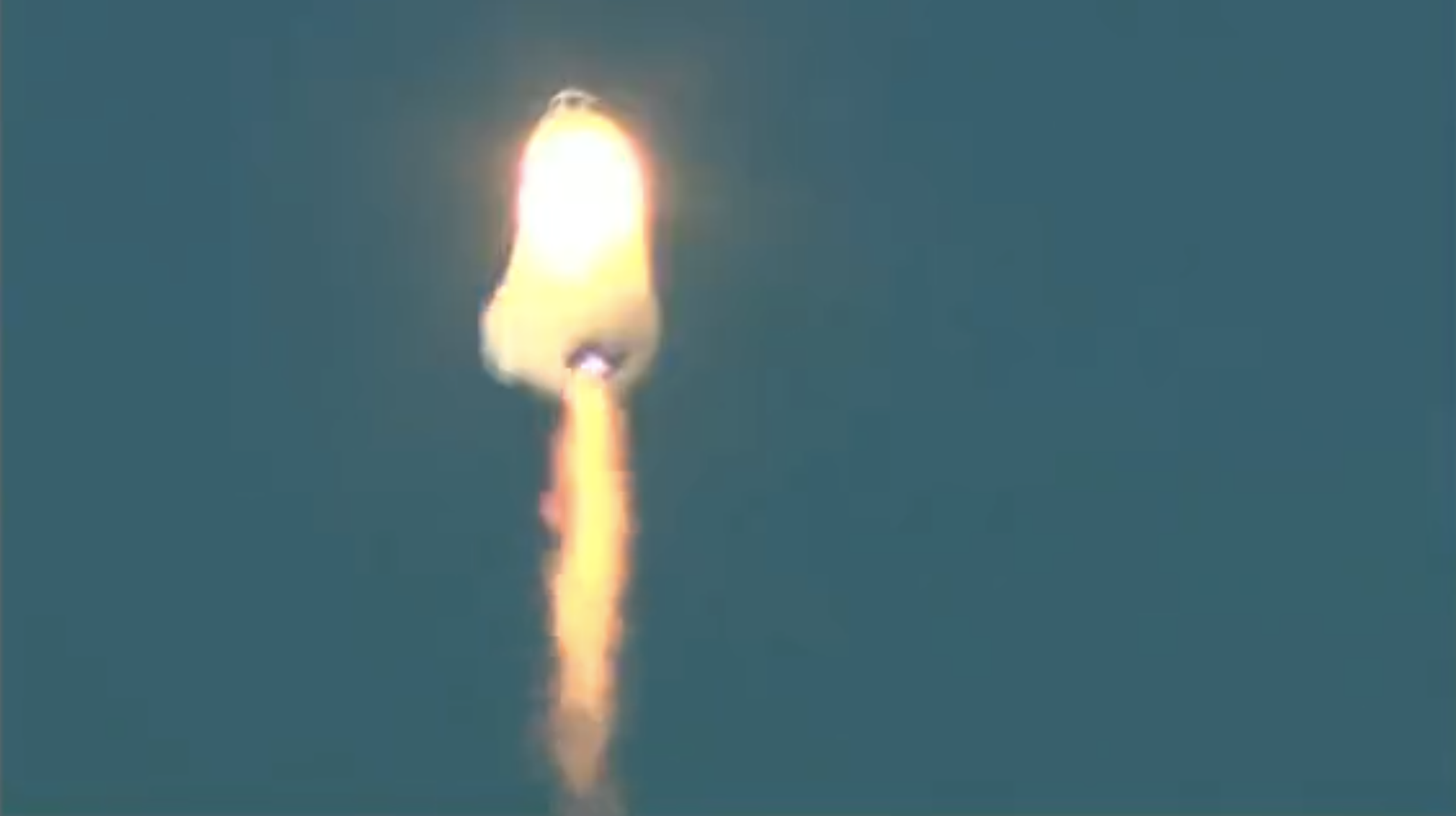 The New Shepard rocket appeared to be completely enveloped in flame, prior to the capsule ejecting from the launch vehicle. (Screenshot: Blue Origin)