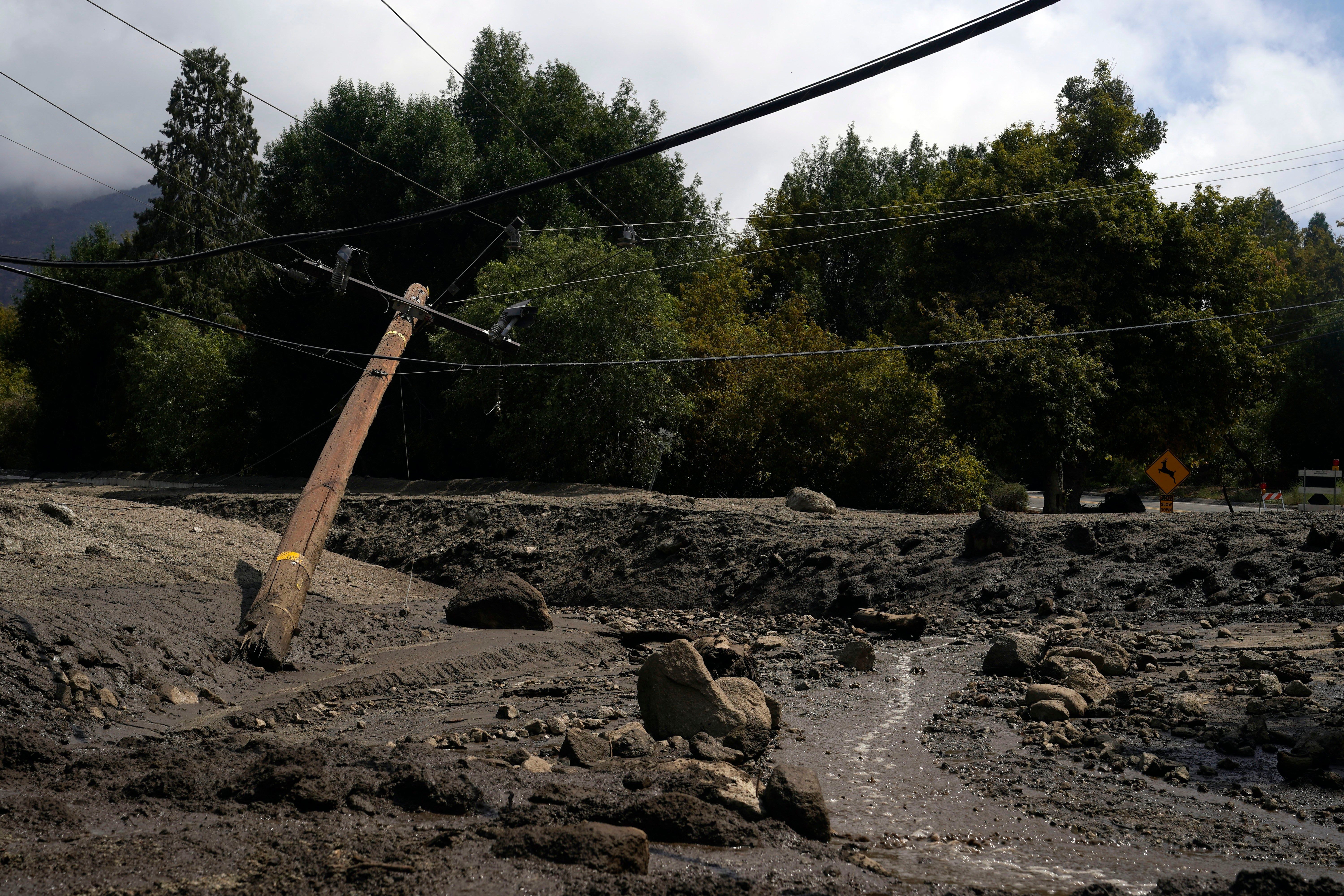 Electric poles are seen half-fallen in the aftermath of a mudslide on Tuesday, Sept. 13, 2022, in Oak Glen, California. (Photo: Marcio Jose Sanchez, AP)