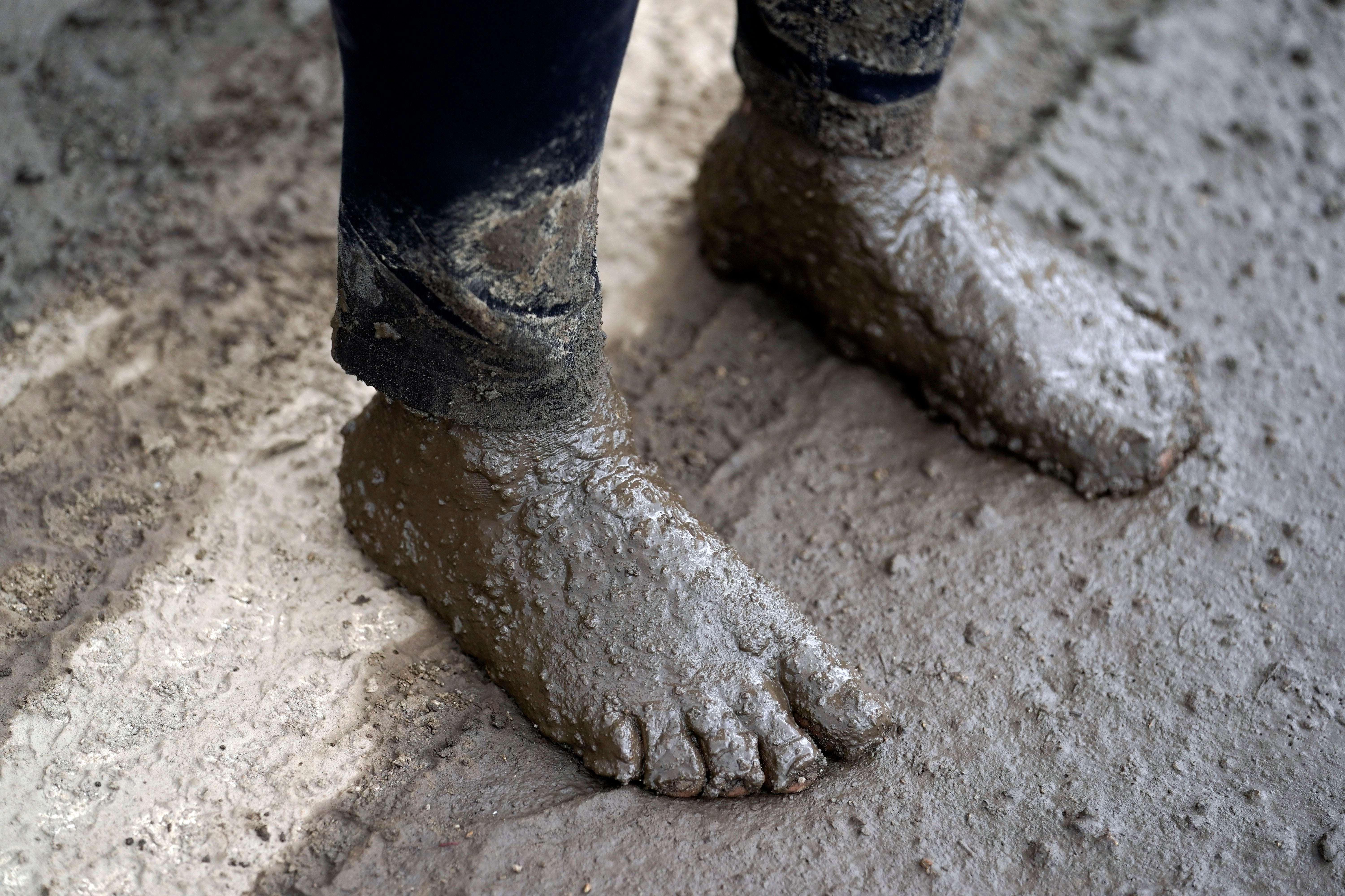 Local resident Perla Halbert's feet, covered in mud after she unsuccessfully tried to reach her property in the aftermath of a mudslide on Tuesday, Sept. 13, 2022, in Oak Glen, California.  (Photo: Marcio Jose Sanchez, AP)