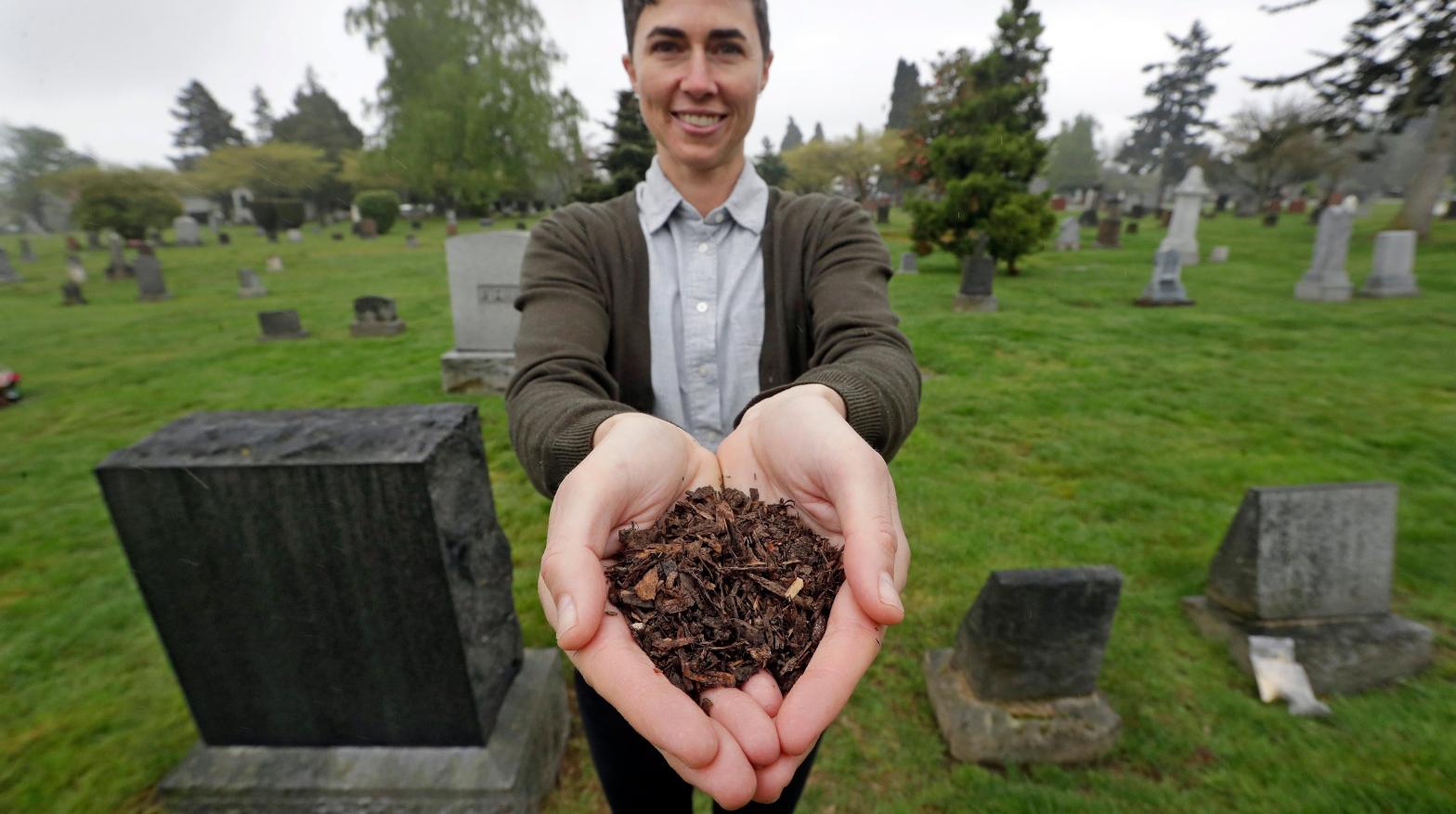 Katrina Spade, the CEO of Recompose, poses with mulch made from a dead cow in 2019. (Photo: Elaine Thompson, AP)