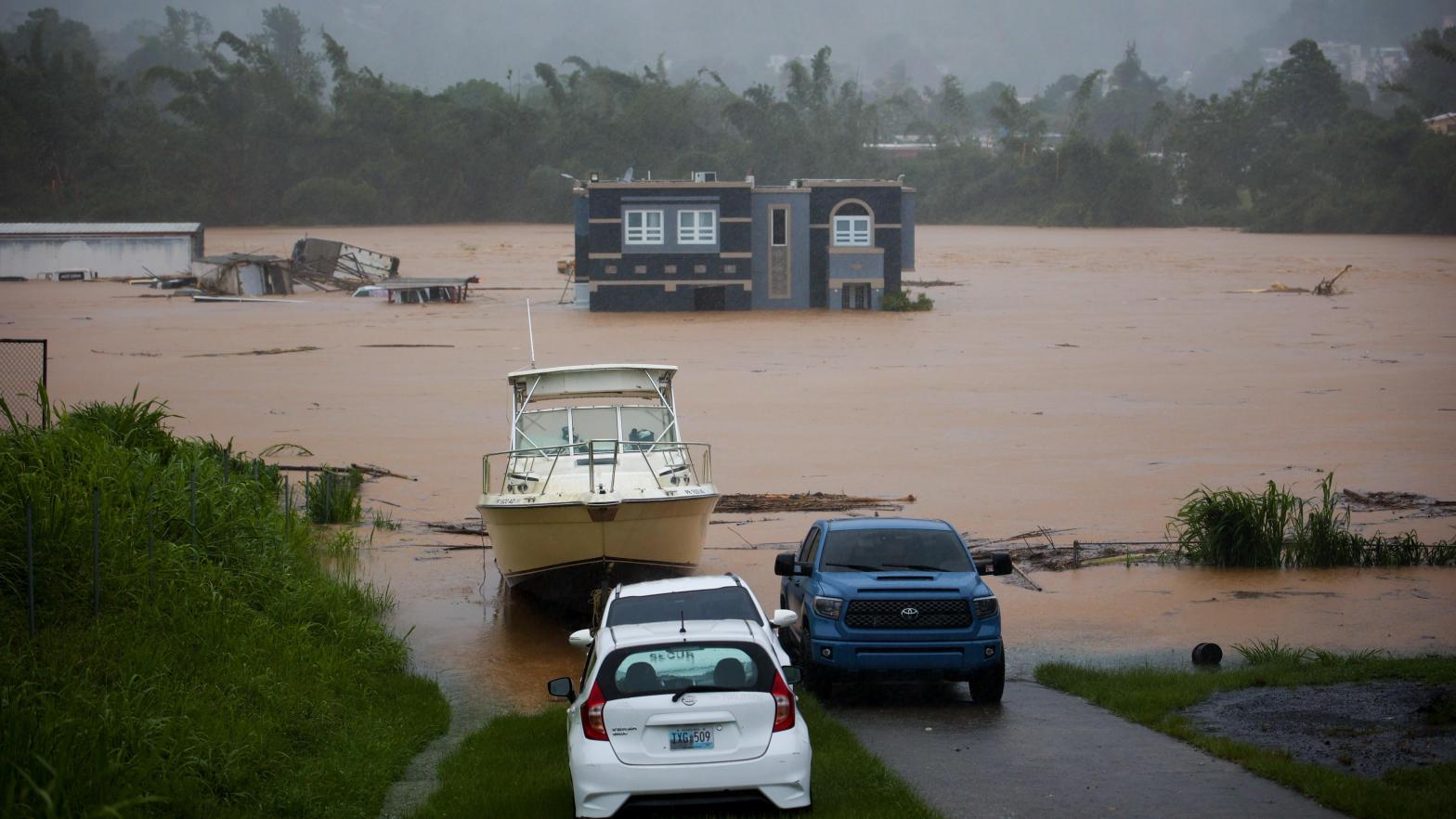 A home is submerged in floodwaters caused by Hurricane Fiona in Cayey, Puerto Rico, on Sunday, September. 18, 2022. According to authorities three people were inside the home and were reported to have been rescued.  (Photo: Stephanie Rojas, AP)