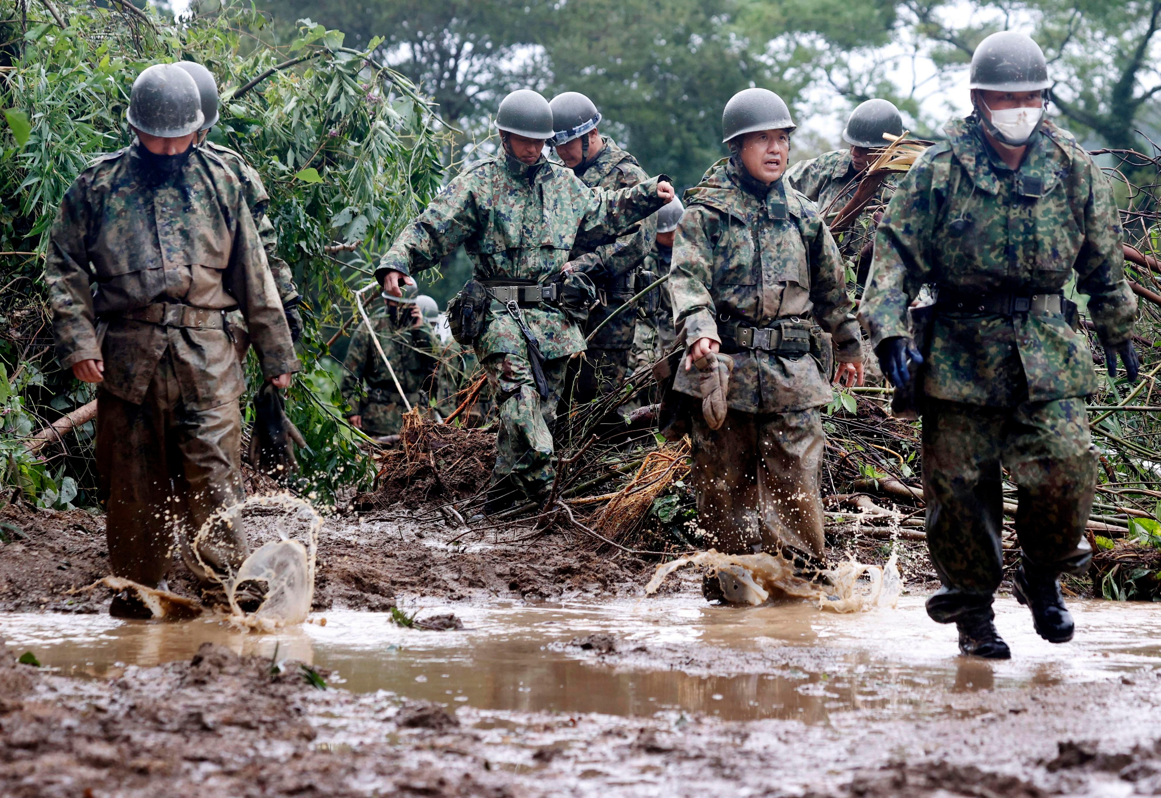 Japanese forces search for the man missing in a mudslide in Mimata on September 19. (Photo: Kyodo, AP)