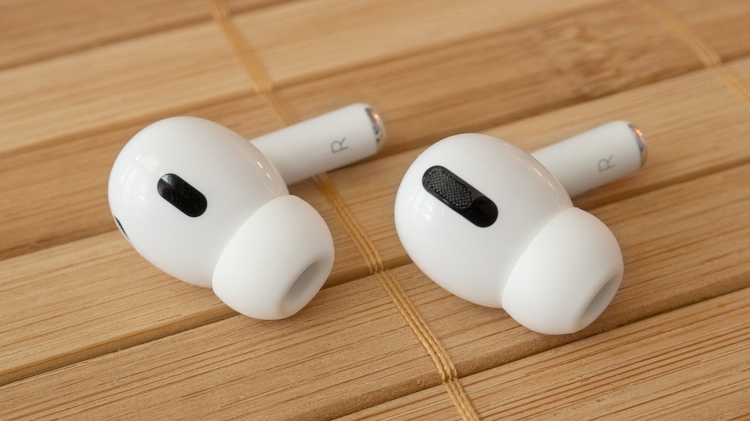 The new Apple AirPods Pro 2nd Gen (left) compared to the original AirPods pro (right), could you tell them apart in the wild. (Photo: Andrew Liszewski | Gizmodo)