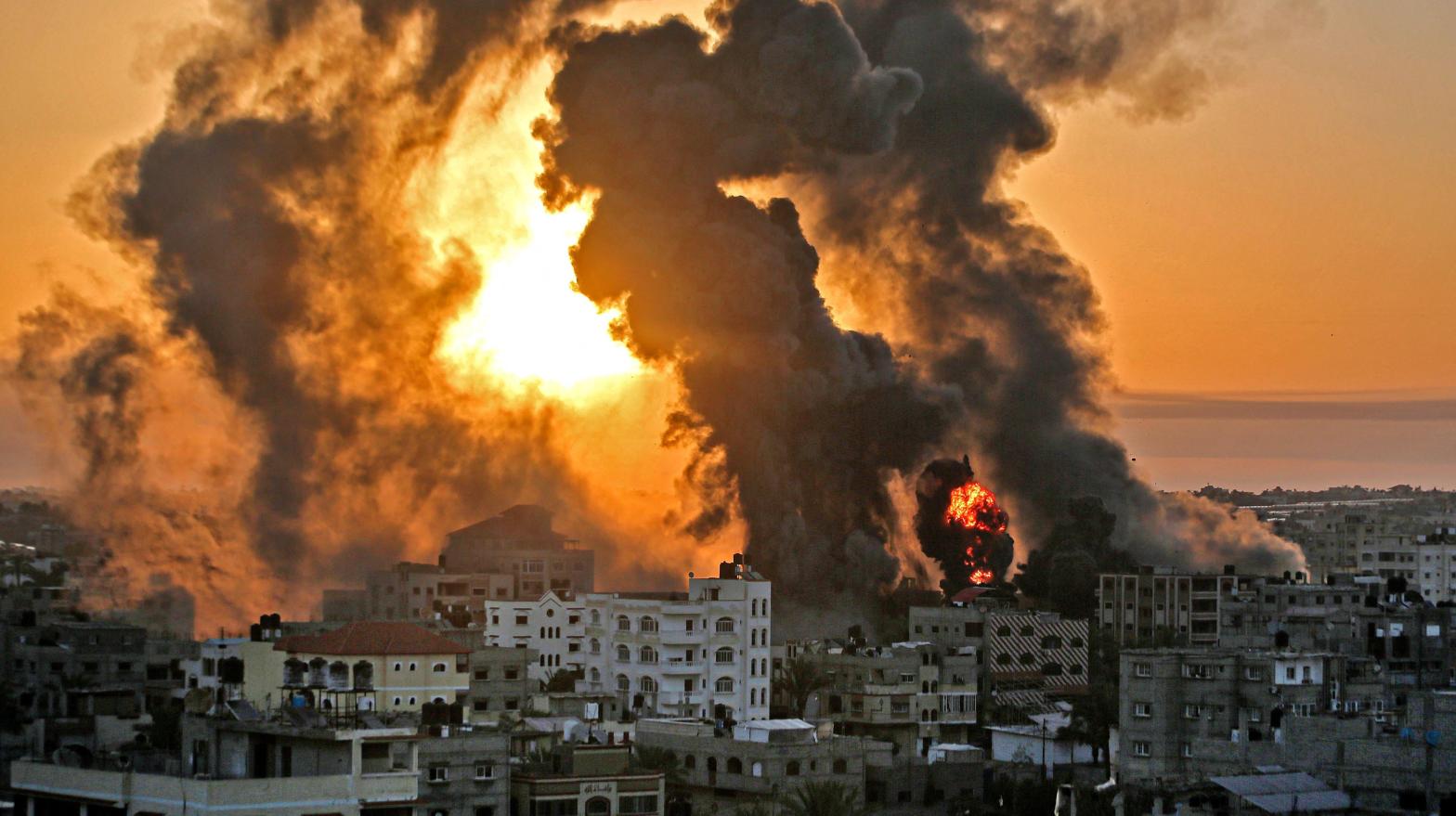 A fire rages at sunrise in Khan Yunish following an Israeli airstrike on targets in the southern Gaza strip, early on May 12, 2021. (Photo: Youssef Massoud, Getty Images)