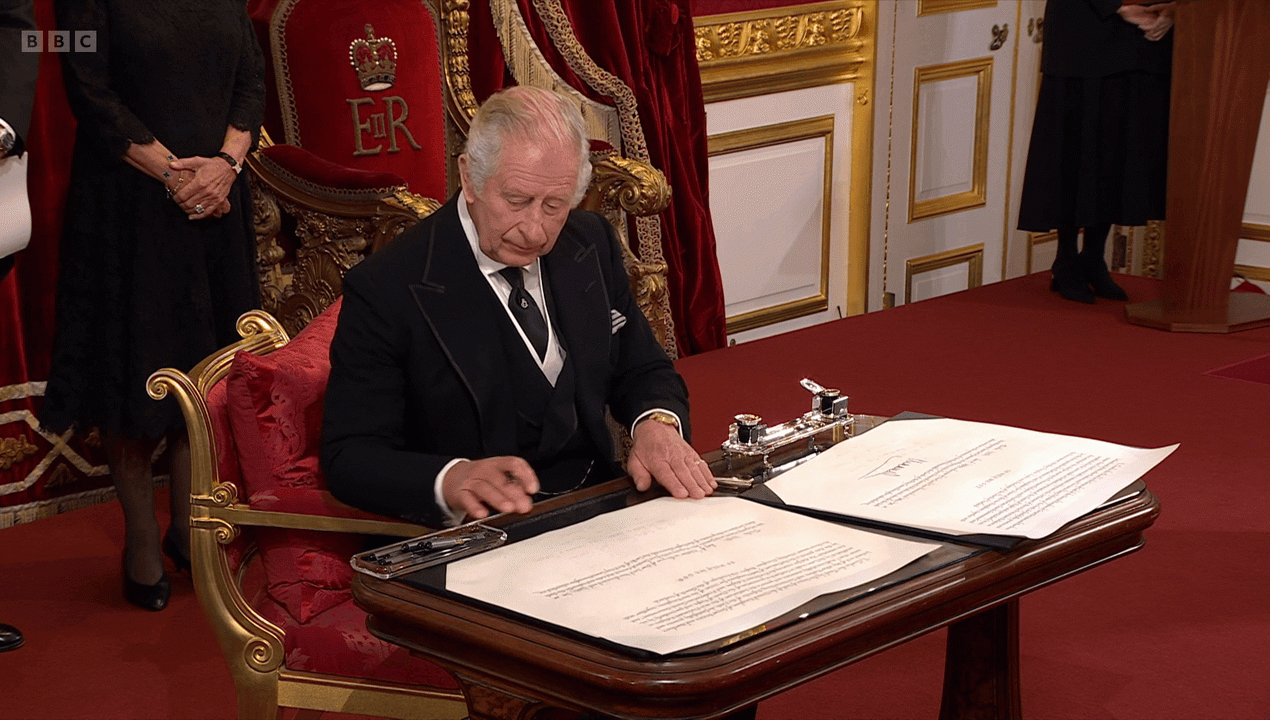 Charles gestures to a servant while declaring himself King in a ceremony at St. James Place in London on September 10, 2022. (Gif: BBC)