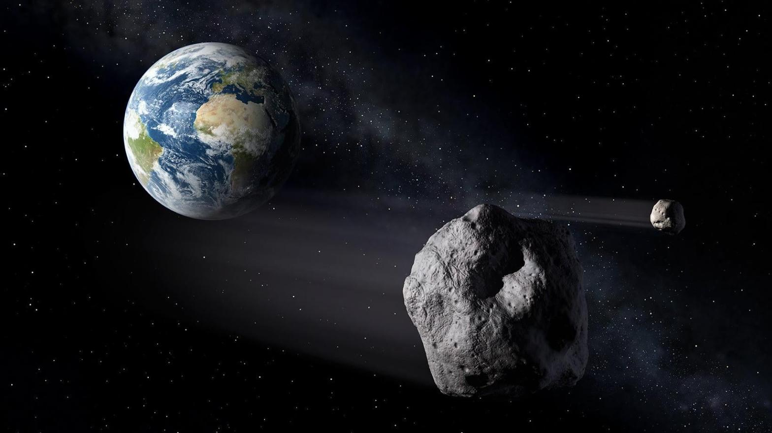 Artist's depiction of a double asteroid system passing by Earth.  (Image: ESA-P.Carril)