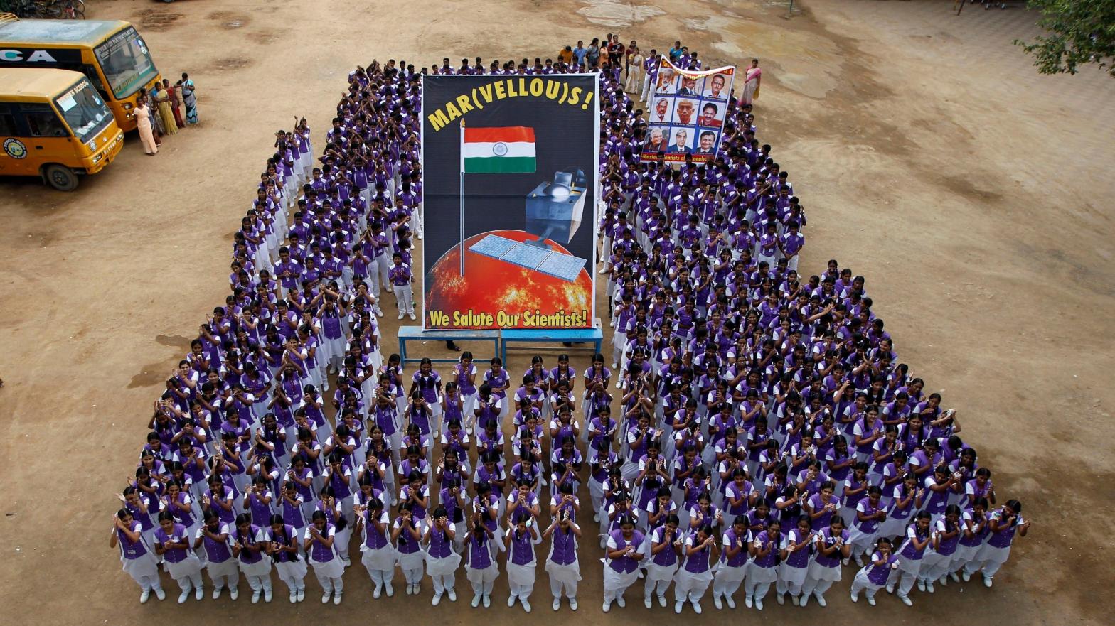 School children in India pose with a poster of the Mars Orbiter Mission. (Photo: ArunSankar K, AP)
