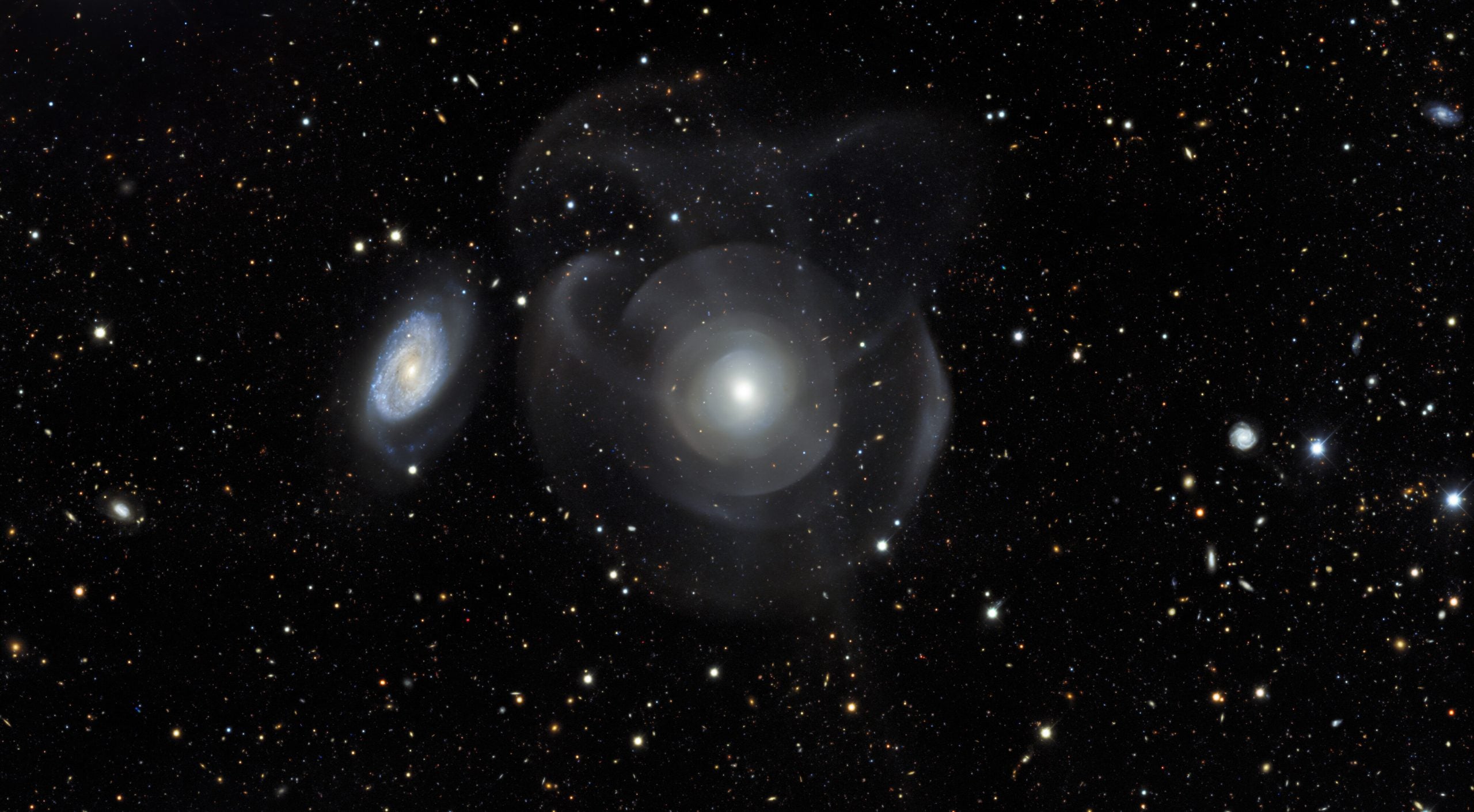 NGC 474 has wispy shells surrounding it. (Image: DES/DOE/Fermilab/NCSA & CTIO/NOIRLab/NSF/AURA; Acknowledgments: Image processing: DES, Jen Miller (Gemini Observatory/NSF’s NOIRLab), Travis Rector (University of Alaska Anchorage), Mahdi Zamani and Davide de Martin)