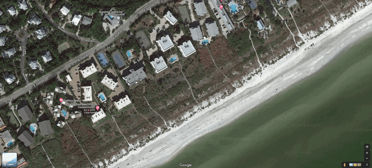 Beach erosion was apparent after Ian on Sanibel Island. Houses roofs were also visibly damaged. (Gif: Gizmodo / NOAA / Google)