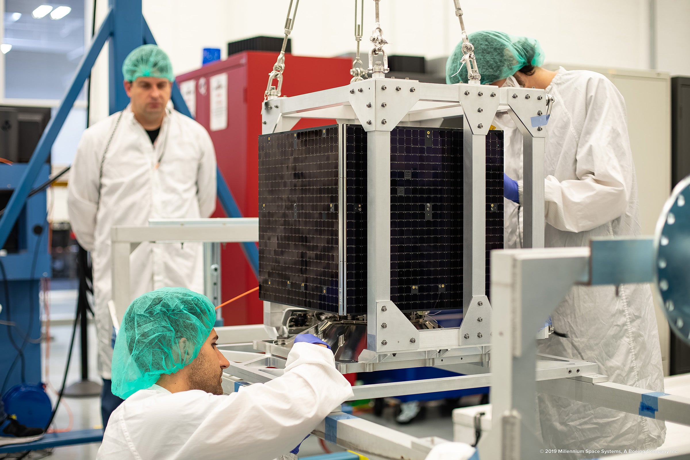 Technicians inspecting the TETRA-1 satellite.  (Photo: Millenium Space Systems)