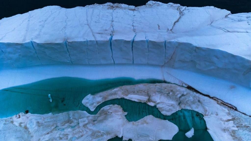 A melting pond is seen inside an iceberg from the Greenland ice sheet in the Baffin Bay near Pituffik, Greenland on July 20, 2022.  (Photo: KEREM YUCEL/AFP, Getty Images)
