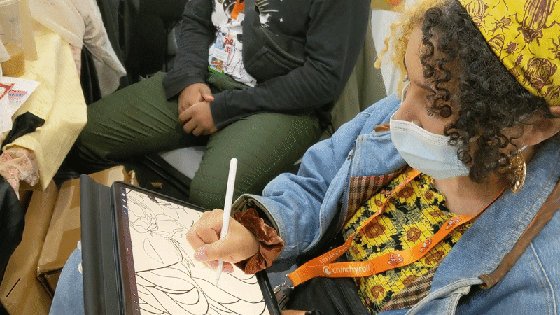 Jasmyn Arnold discusses how they're inspired by their own mistakes as they sketch the outline for their piece. (Gif: Kyle Barr/io9)