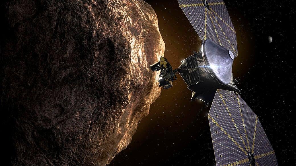 An illustration of the Lucy spacecraft flying past one of the Trojan asteroids.  (Illustration: NASA)
