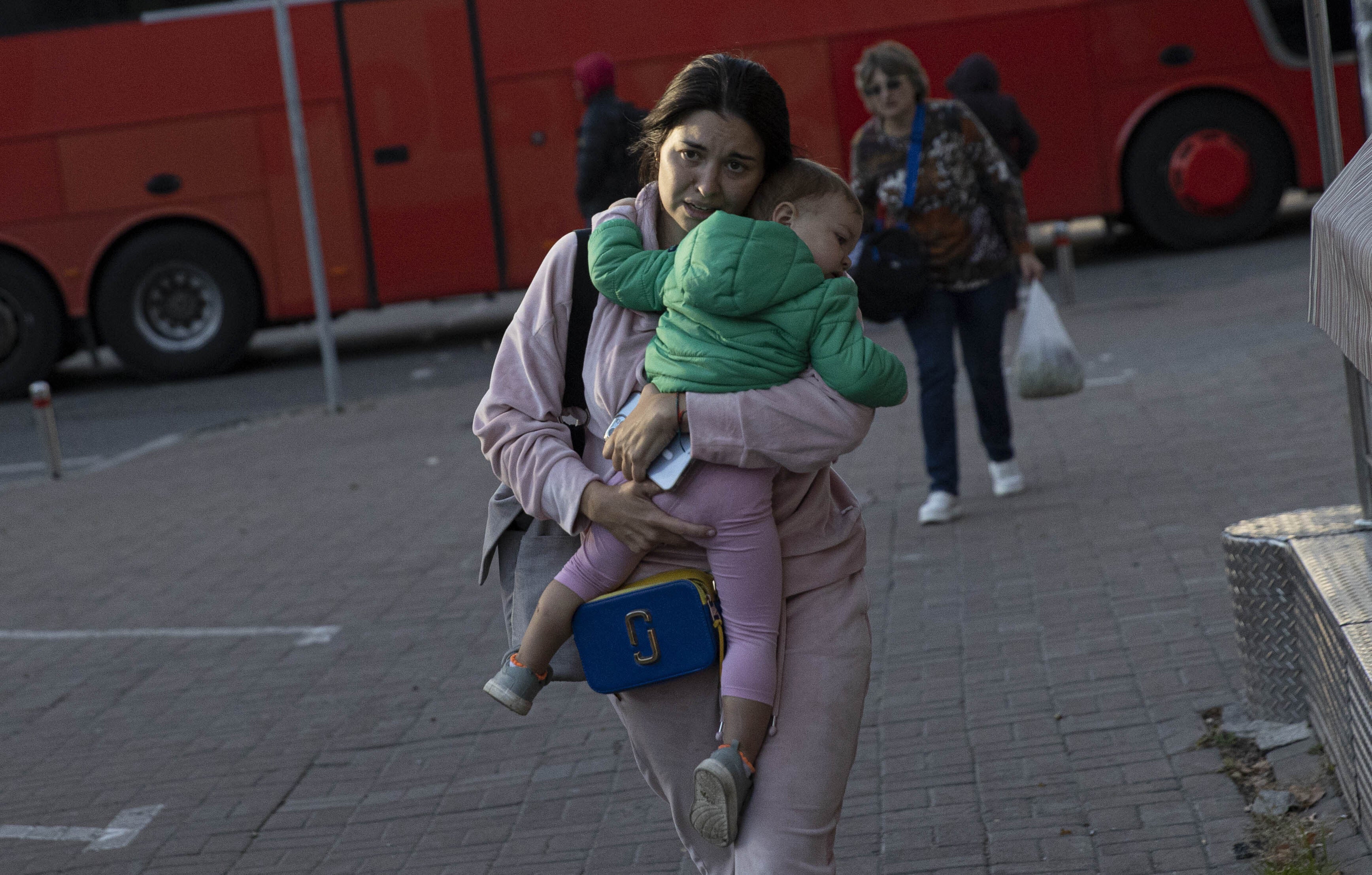 A Ukrainian woman is seen with her child after the Russian attacks in Kyiv, Ukraine on October 17, 2022.  (Photo: Metin Aktas/Anadolu Agency, Getty Images)