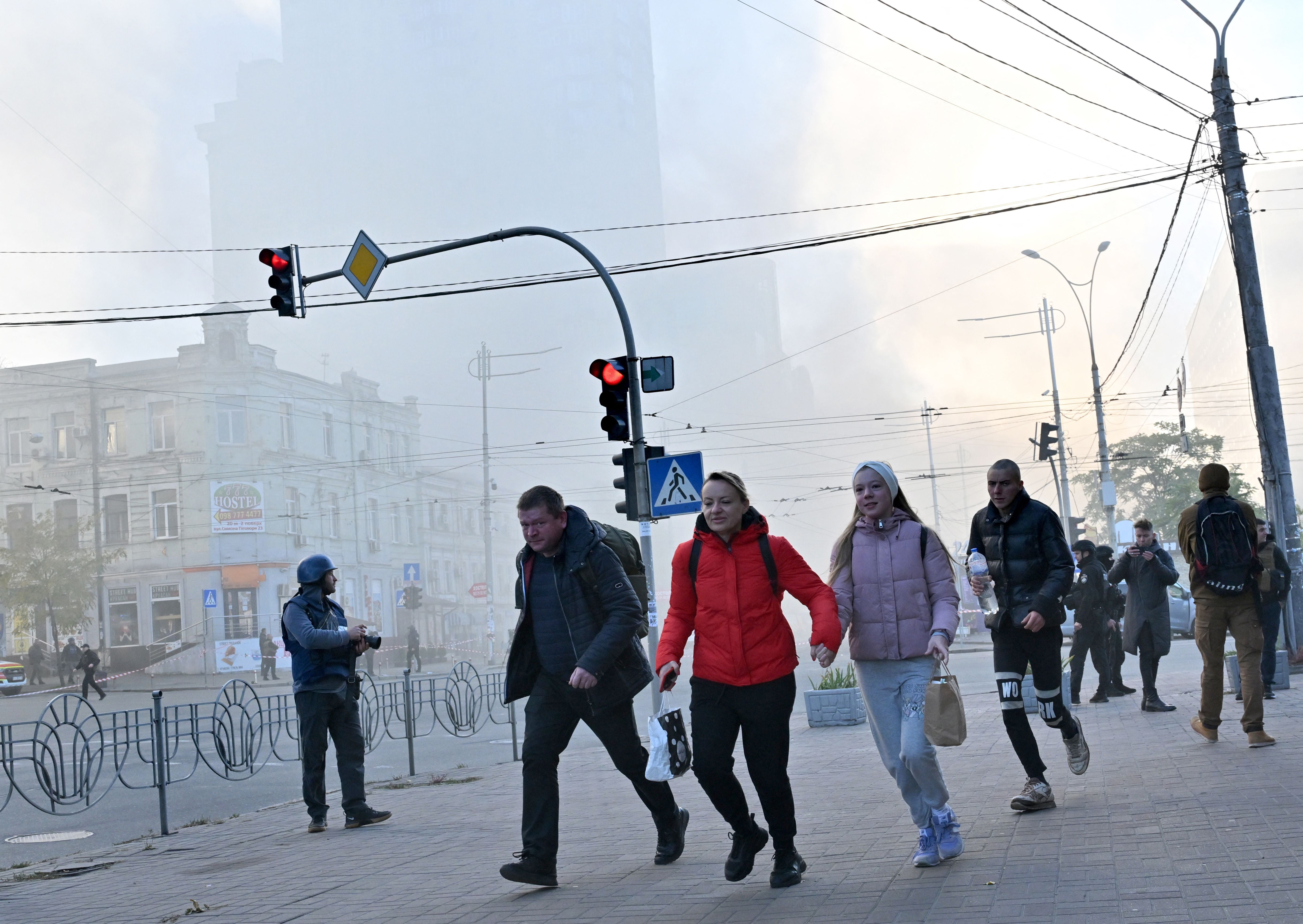 Local residents run away after a drone attack in Kyiv on October 17, 2022, amid the Russian invasion of Ukraine. (Photo: Sergei Supinsky / AFP, Getty Images)
