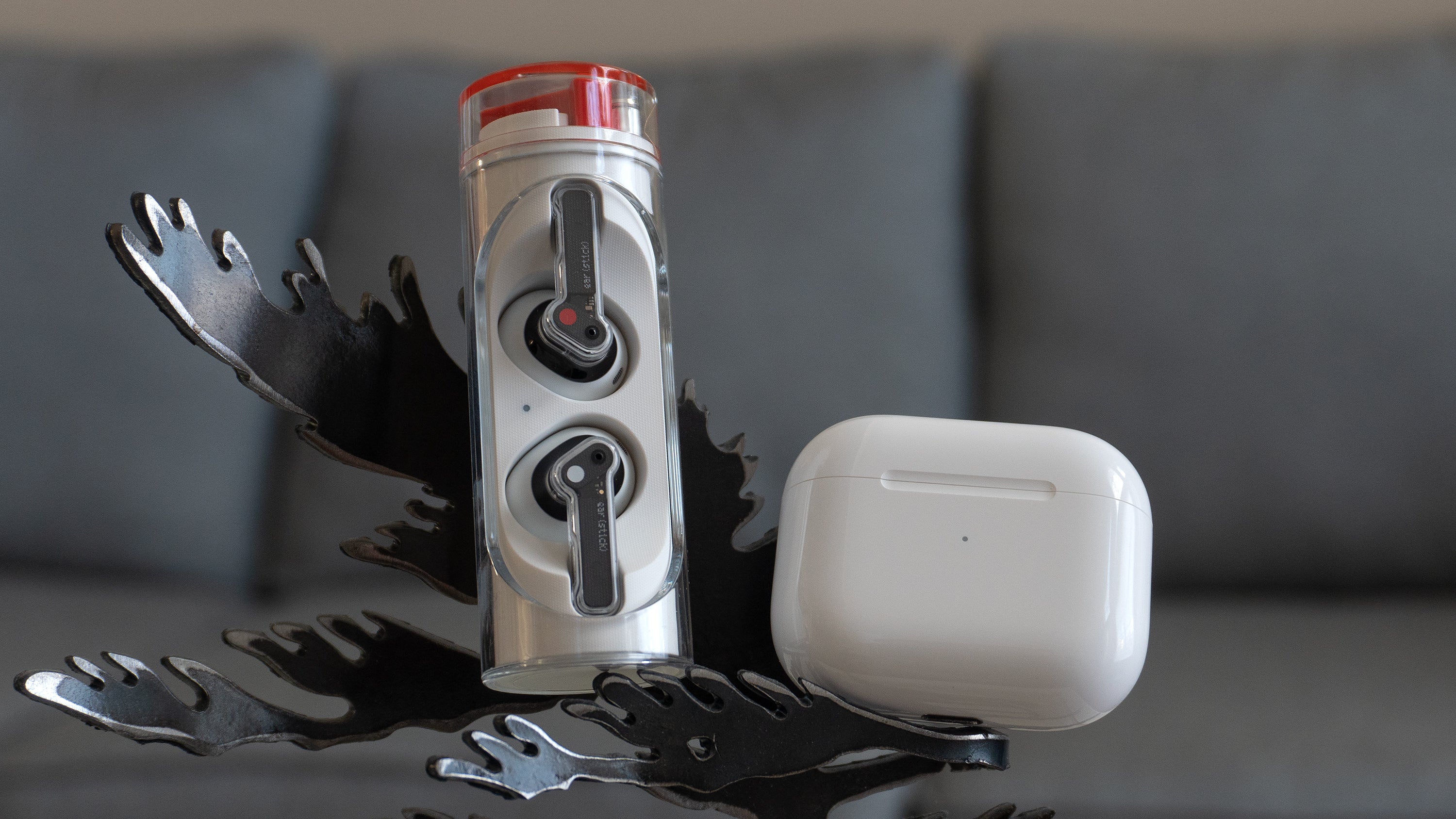 The Nothing Ear (stick)'s cylindrical charging case compared to the third-gen AirPods very compact charging case (right). (Photo: Andrew Liszewski | Gizmodo)