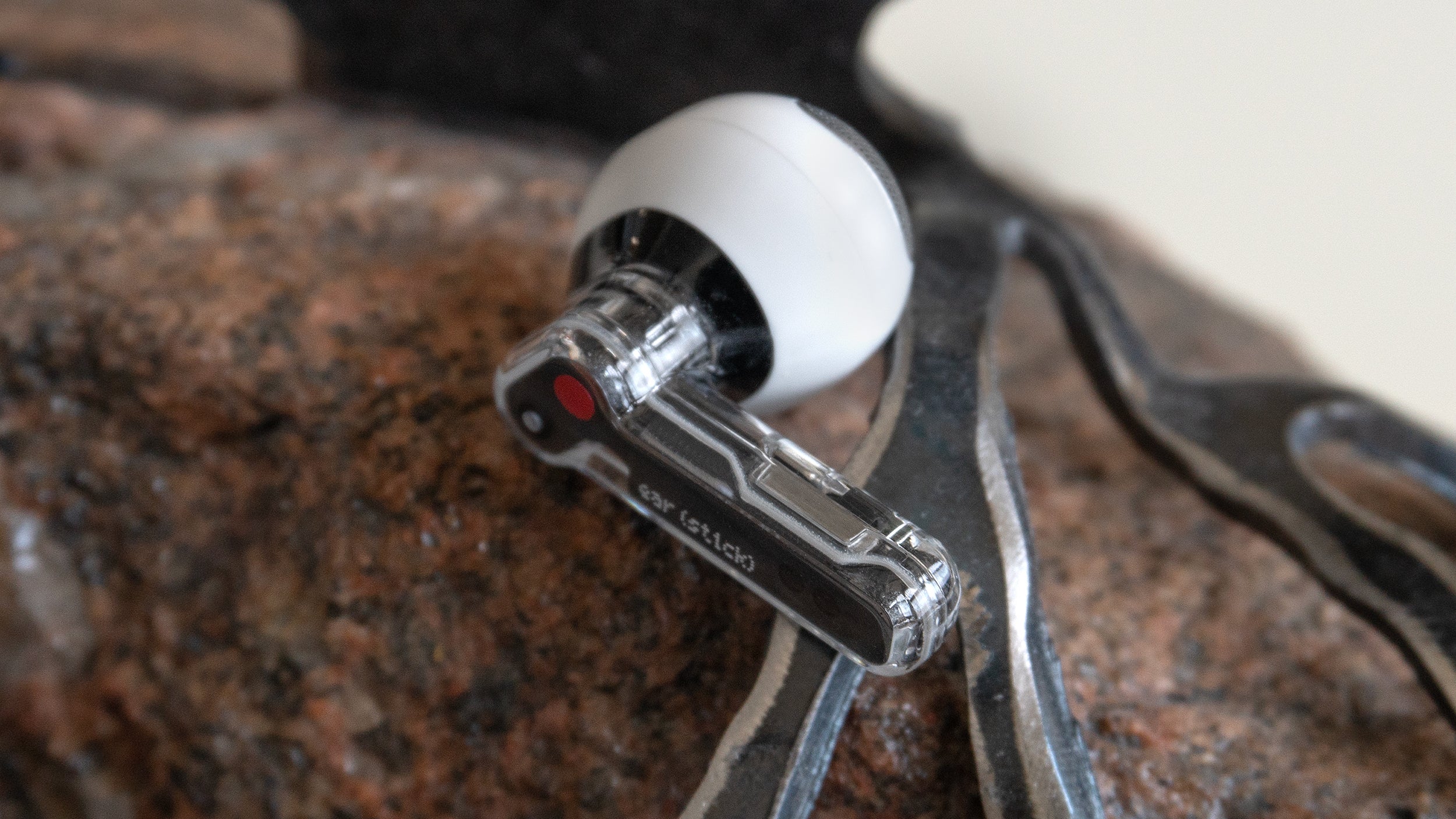 The squeeze controls on the Ear (stick)'s stem are easier and more reliable to use than the third-gen AirPod's. (Photo: Andrew Liszewski | Gizmodo)