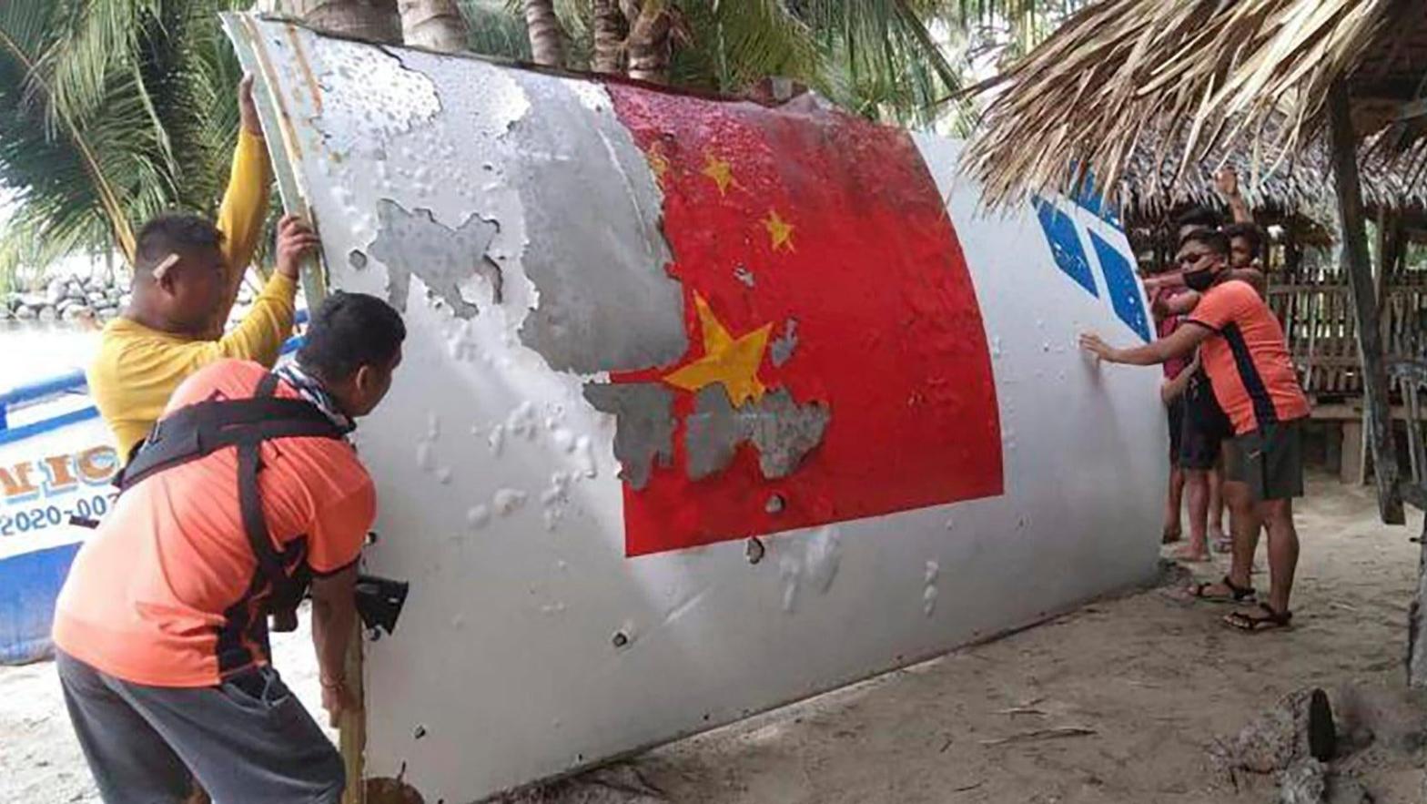 The Philippine Coast Guard inspecting debris from a Long March 5B rocket launched on July 24, 2022. (Photo: Philippine Coast Guard, AP)