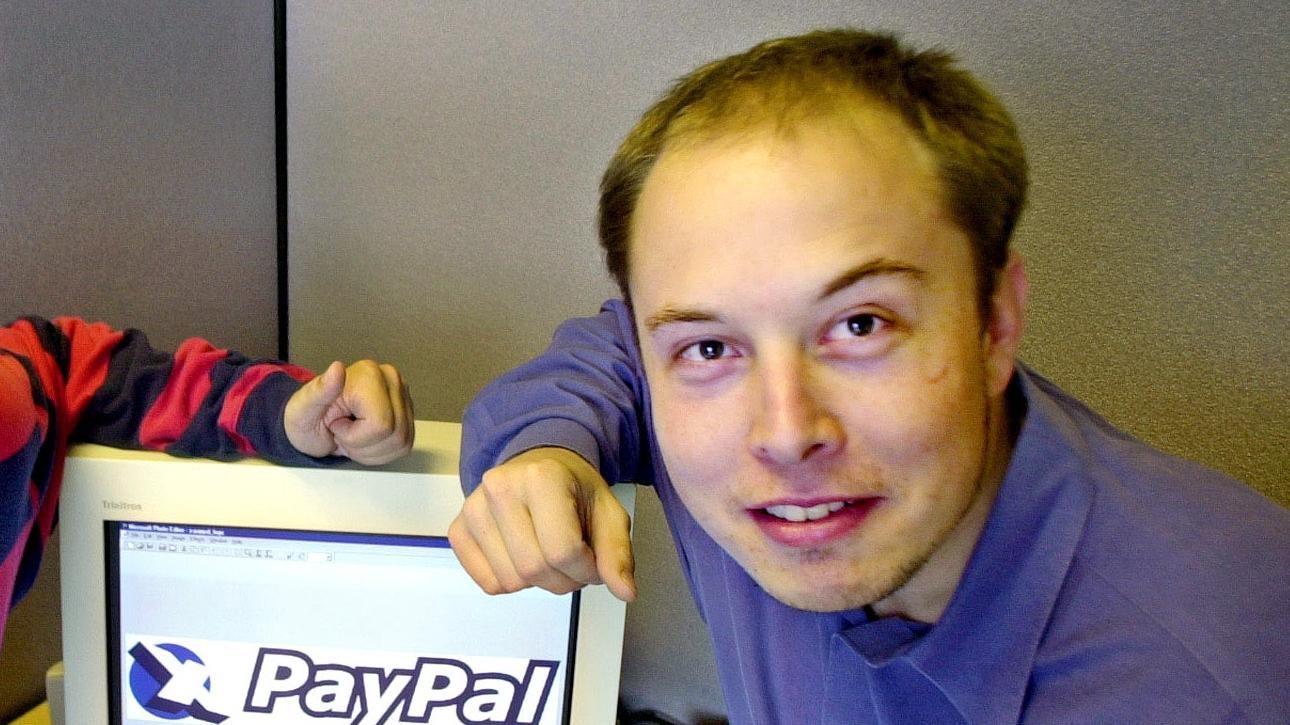 Elon Musk in a file photo from Oct. 20, 2000 posing with the PayPal logo at PayPal's corporate headquarters in Palo Alto, Calif (Photo: Paul Sakuma, File, AP)
