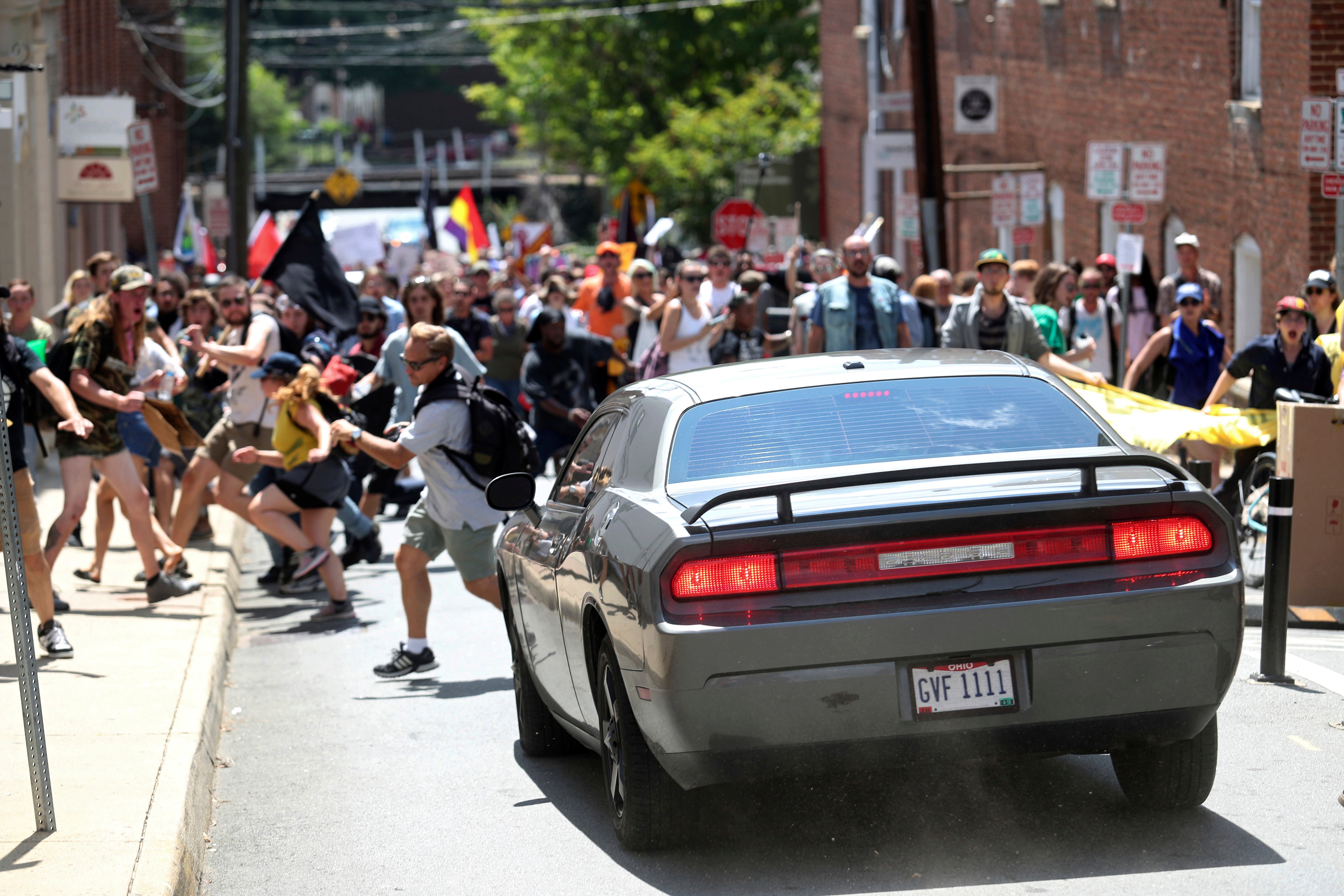 A vehicle drives into a group of protesters demonstrating against a white nationalist rally in Charlottesville, Va. on Aug. 12, 2017, resulting in dozens of injuries and the death of 32-year-old Heather Heyer. (Photo: Ryan M. Kelly, AP)
