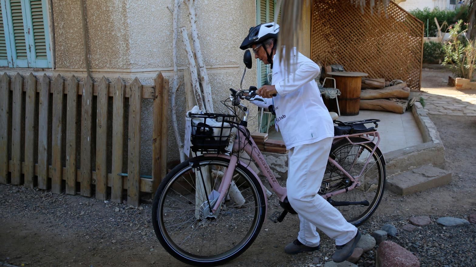 Dorothee Hildebrandt, 72, sets out from her host's apartment to ride her bike to the U.N. climate summit COP27 in Sharm el-Sheikh, Egypt, Saturday, Nov. 12, 2022. (Photo: Thomas Hartwell, AP)