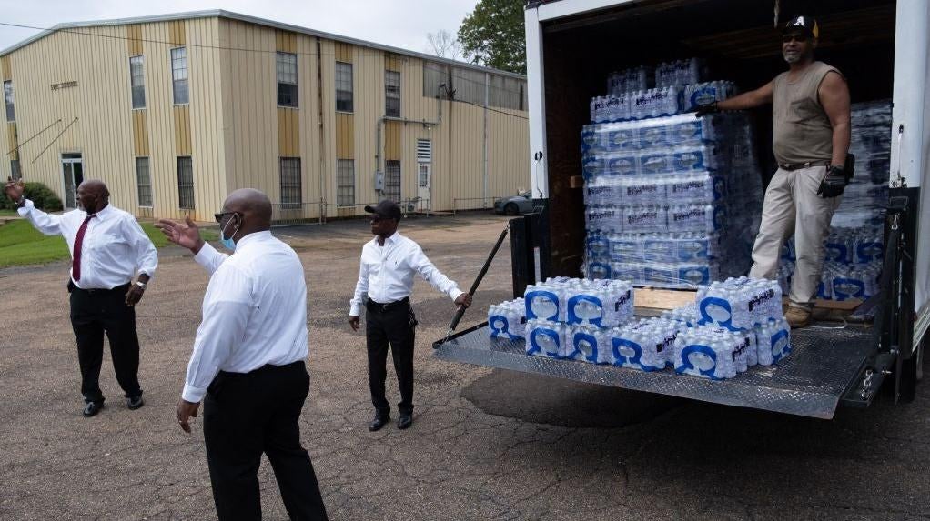 Members of Progressive Morningstar Baptist Church direct people to get bottled water following a Sunday morning service in Jackson, Mississippi, on September 4, 2022.  (Photo: SETH HERALD/AFP, Getty Images)