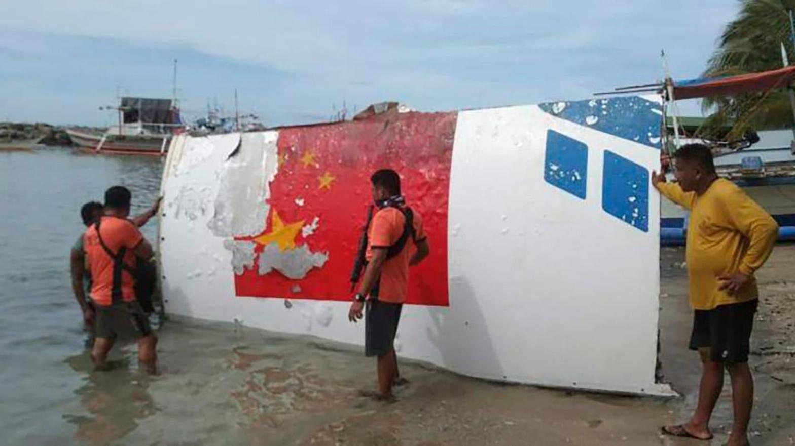 Rescuers recovering debris, which the Philippine Space Agency said has markings of the Long March 5B Chinese rocket that was launched on July 24, after it was found in waters off Mamburao, Occidental Mindoro province, Philippines, on Aug. 2, 2022. (Photo: Philippine Coast Guard, AP)