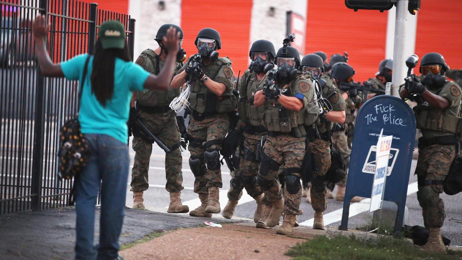Police force protestors from the business district into nearby neighbourhoods on August 11, 2014 in Ferguson, Missouri following the killing of Michael Brown at the hands of police. (Photo: Scott Olson, Getty Images)