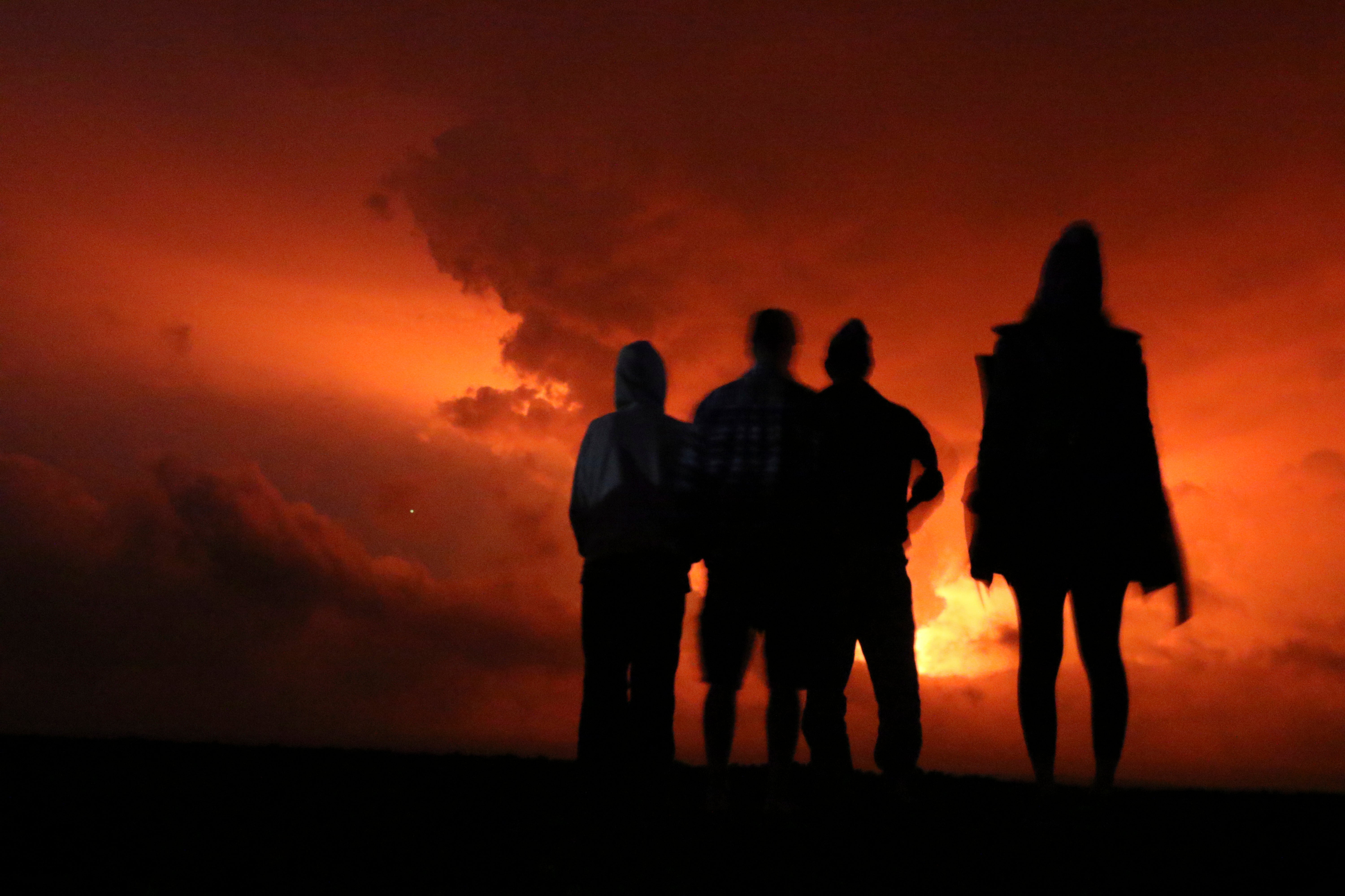 People watch Mauna Loa erupt on Monday, November 28, 2022. (Photo: Caleb Jones, AP)