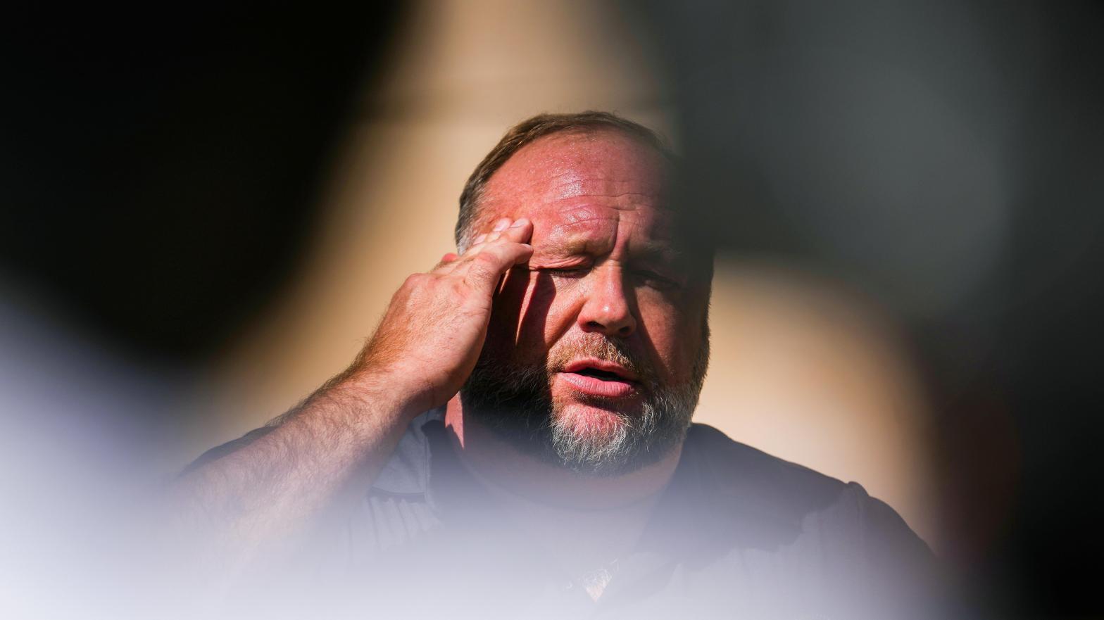 Alex Jones ranted outside a Connecticut courtroom this past October after being told he would need to pay nearly $US1 ($1) billion in damages to the parents of victims from the Sandy Hook school shooting.  (Photo: Joe Buglewicz, Getty Images)