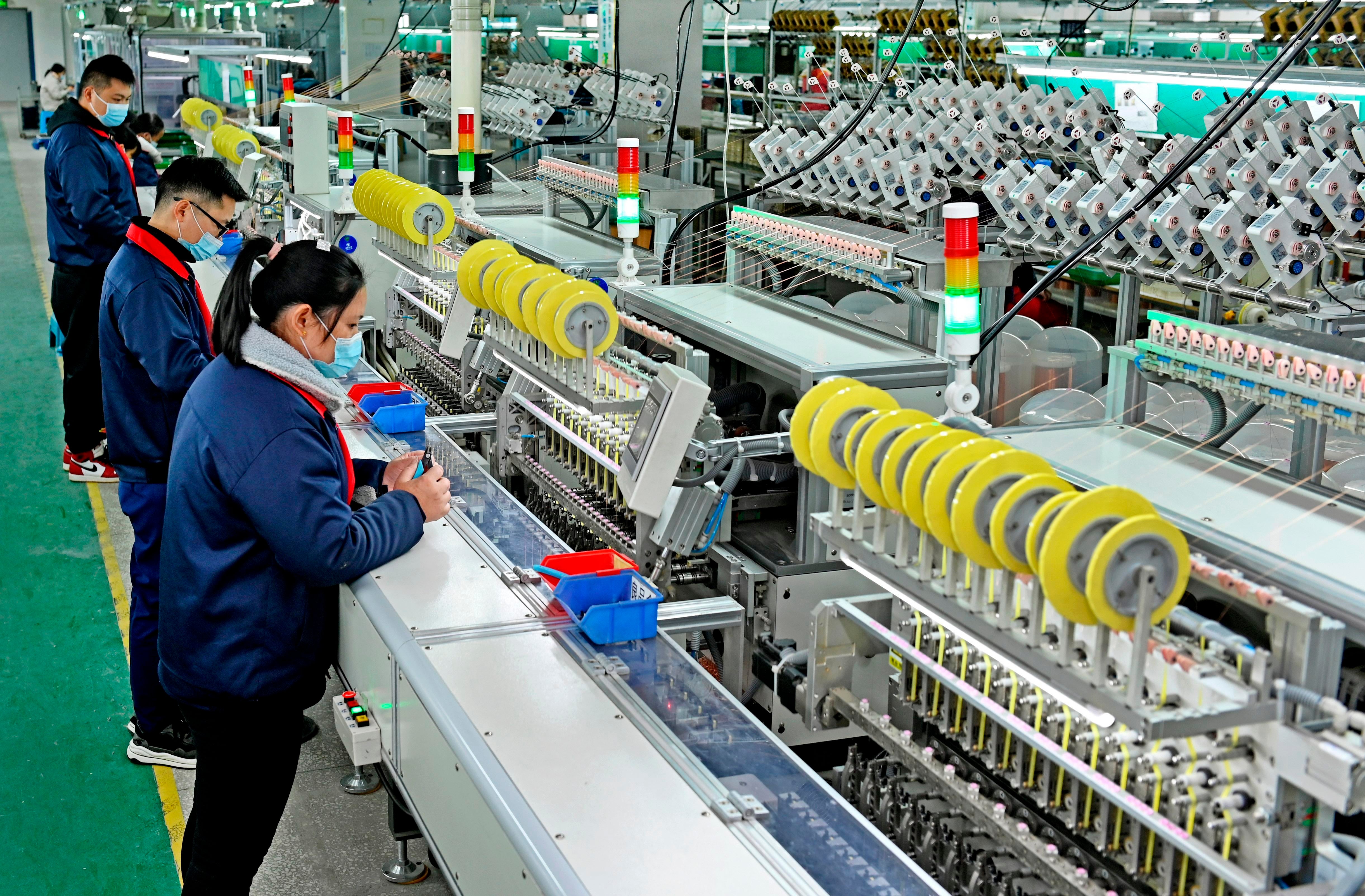 Workers are busy producing electronic products in Dongkou County,  Shaoyang City, south China's Hunan Province, December 7, 2022.  (Photo: Imaginechina, AP)