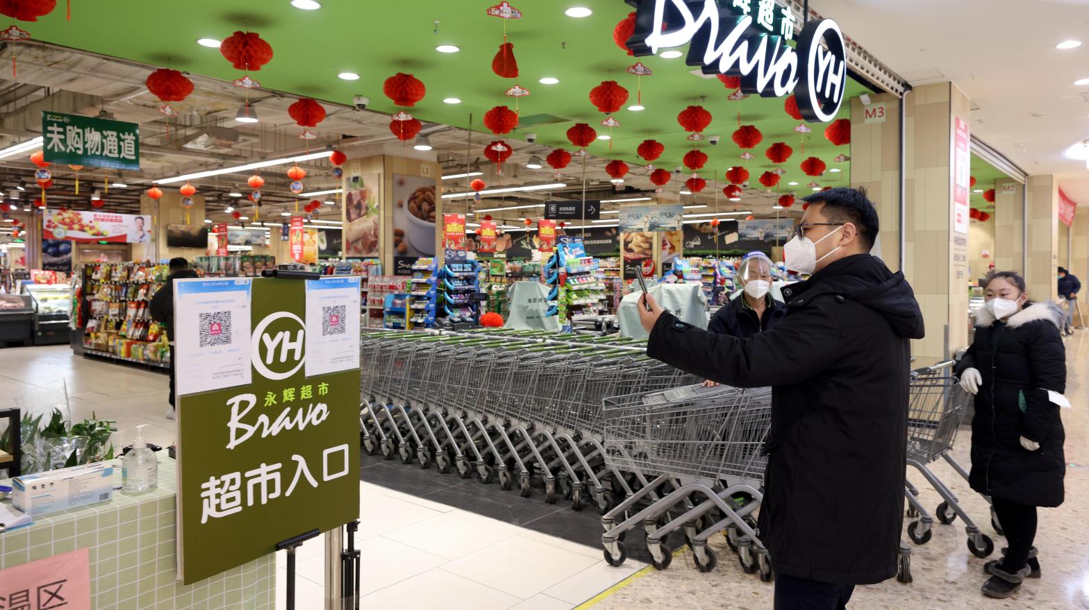 A man scans his health code at the entrance of a supermarket on December 6, 2022 in Beijing,  China.  (Photo: Zhang Yu/China News Service, Getty Images)
