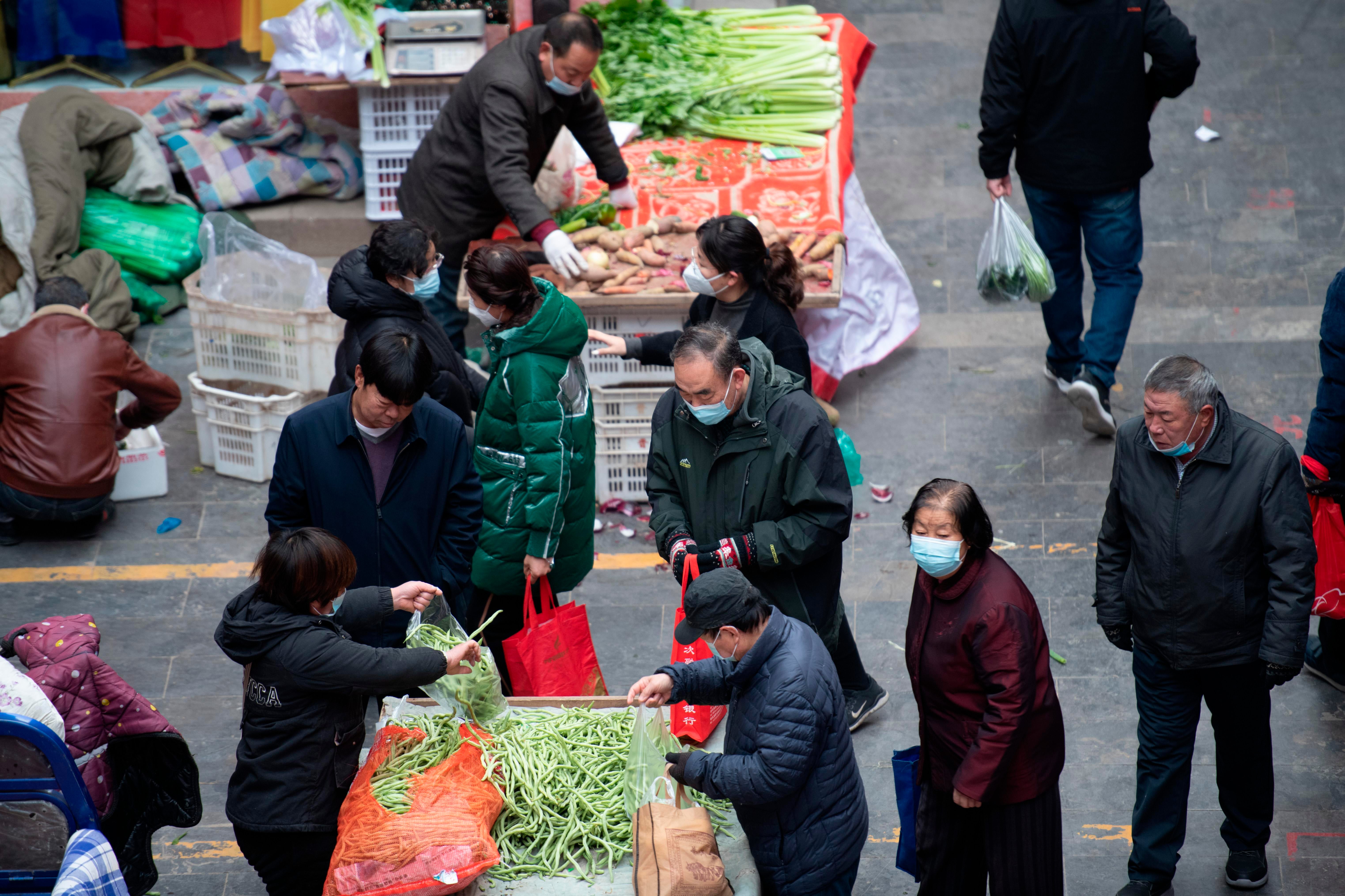 Citizens buy vegetables and food in Kaihua Temple Market in Taiyuan City, north China's Shanxi Province, December 7, 2022. (Photo: Imaginechina, AP)
