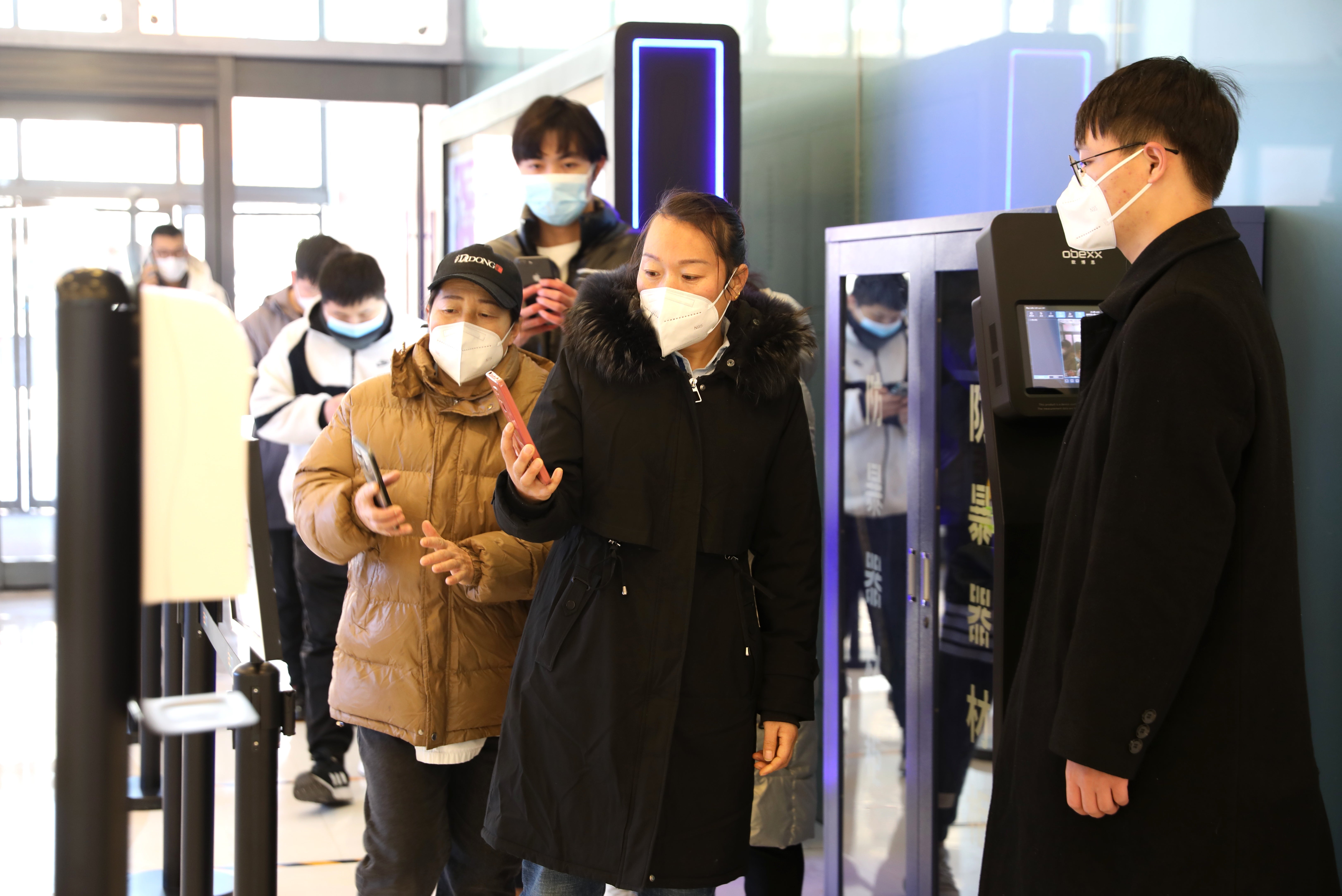 Customers scan their health codes at the entrance of a shopping mall as  Beijing no longer requires people to show their negative nucleic acid  testing results before entering public places on December 6, 2022 in  Beijing, China. (Photo: Zhao Jun/China News Service, Getty Images)