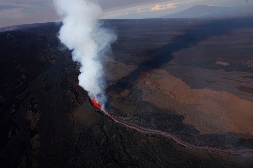 In an aerial view, lava shoots up from a fissure of Mauna Loa Volcano as it erupts on December 05, 2022 in Hilo, Hawaii. (Photo: Justin Sullivan, Getty Images)