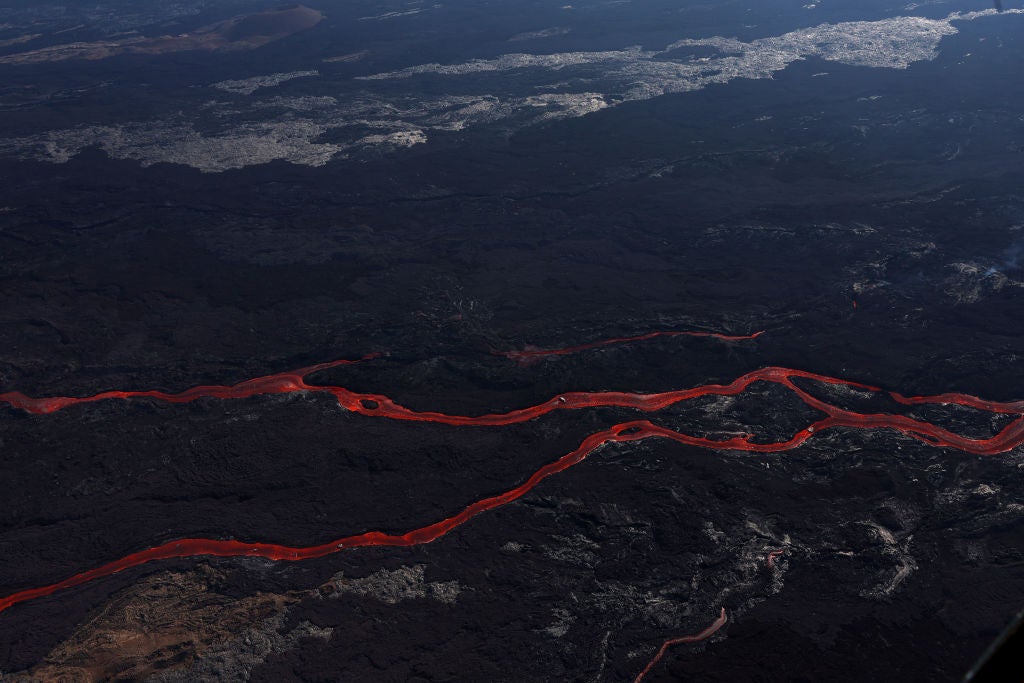 In an aerial view, lava flows from a fissure of Mauna Loa Volcano as it erupts on December 05, 2022 in Hilo, Hawaii. (Photo: Justin Sullivan, Getty Images)