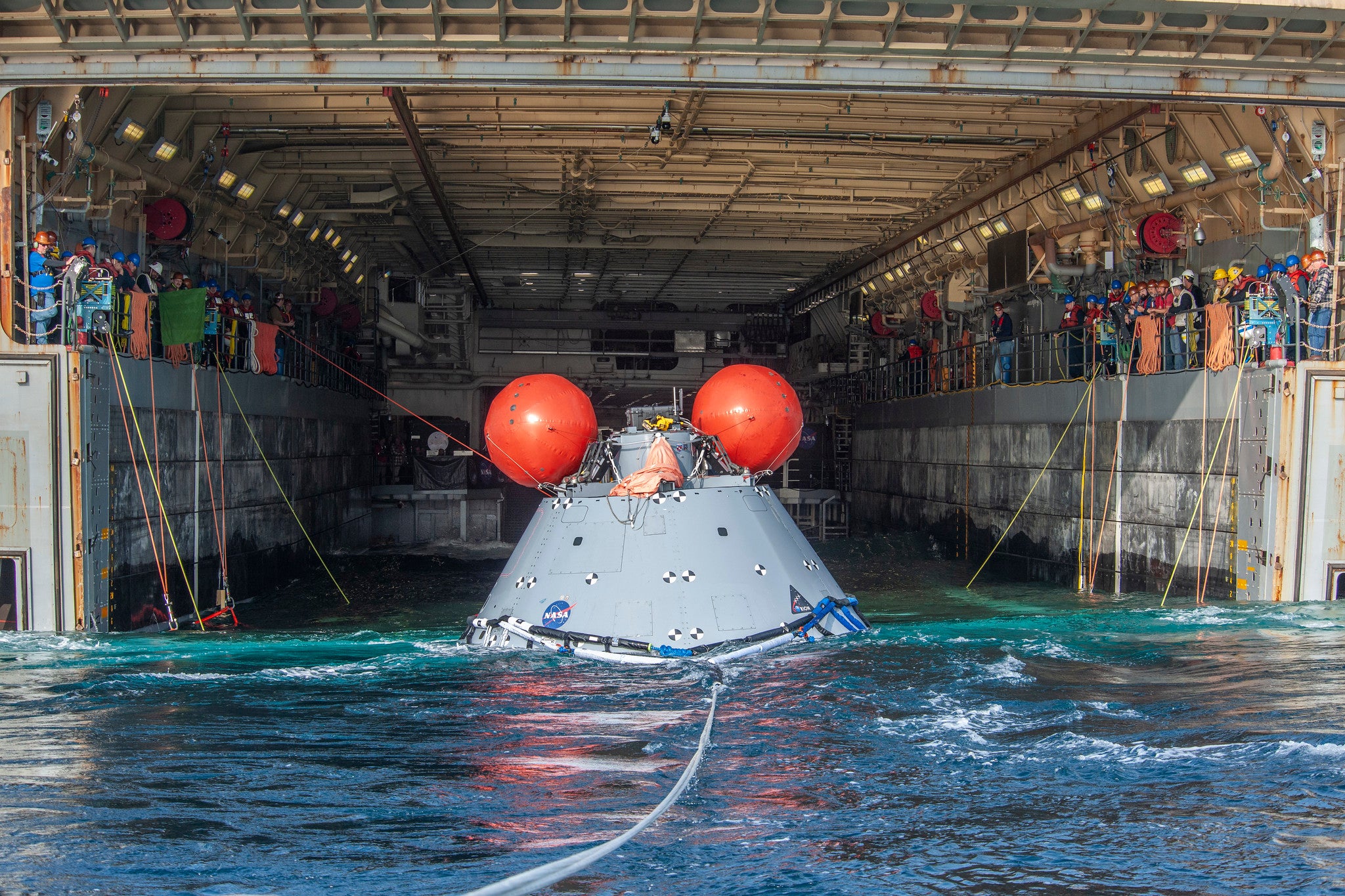 An Orion mockup being delivered to the well deck of a Navy vessel during a practice exercise held on December 2, 2022.  (Photo: NASA)