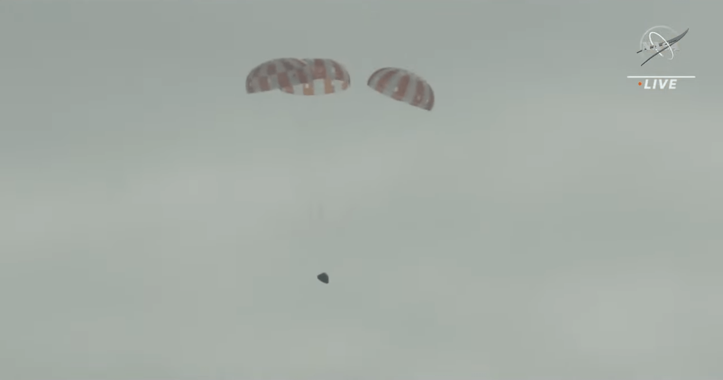 The first view of Orion during its parachute-assisted descent. (Screenshot: NASA TV)