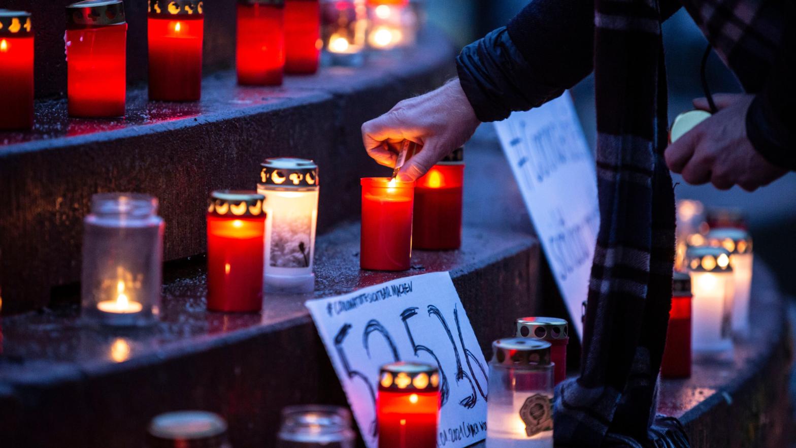 People attending a makeshift memorial for covid-19 victims at Arnswalder Platz on January 24, 2021 in Berlin, Germany. (Photo: Omer Messinger, Getty Images)