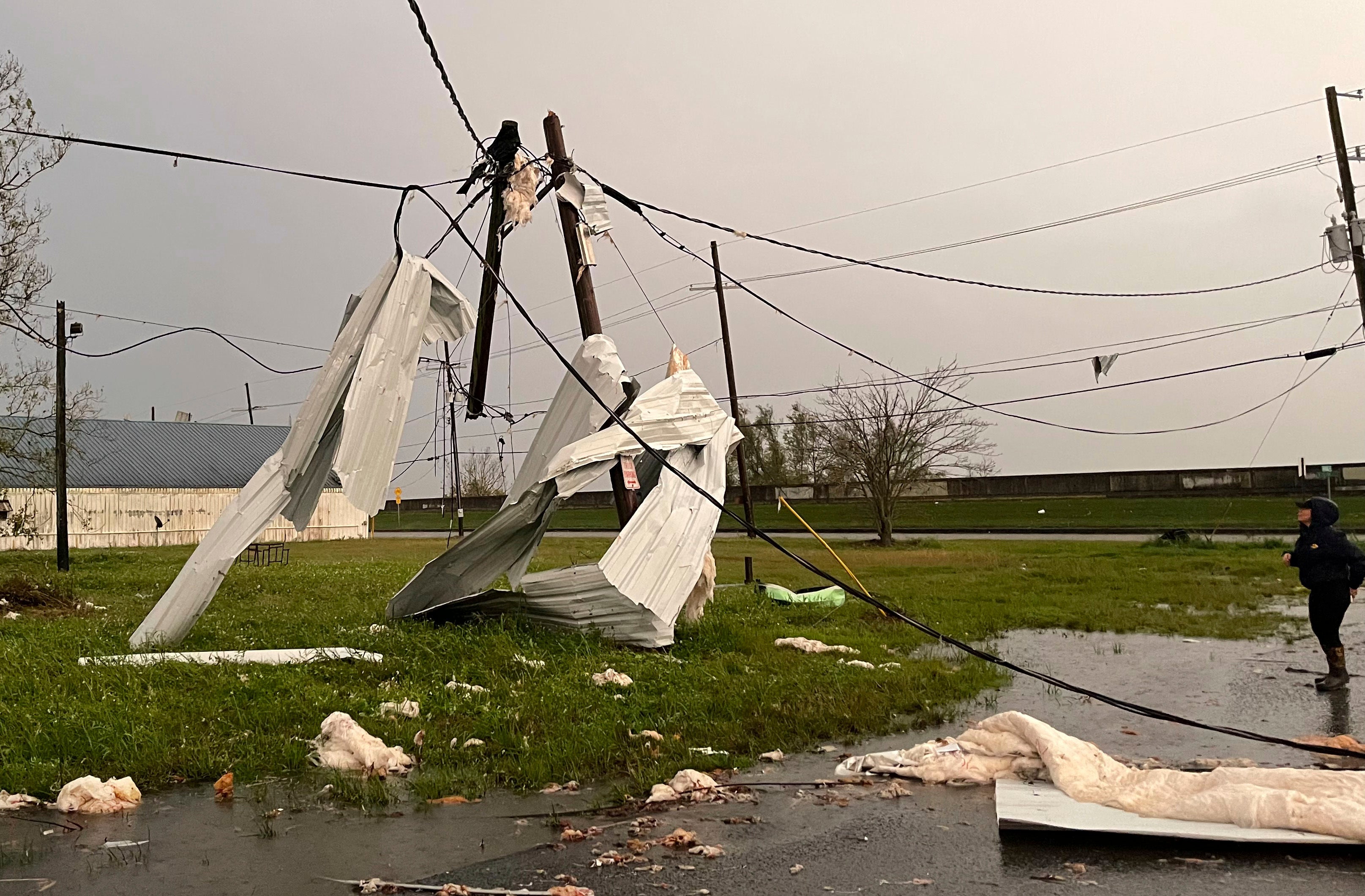 Sheet metal wrapped around utility poles in Arabi, Louisiana. (Photo: Matthew Hinton, AP)